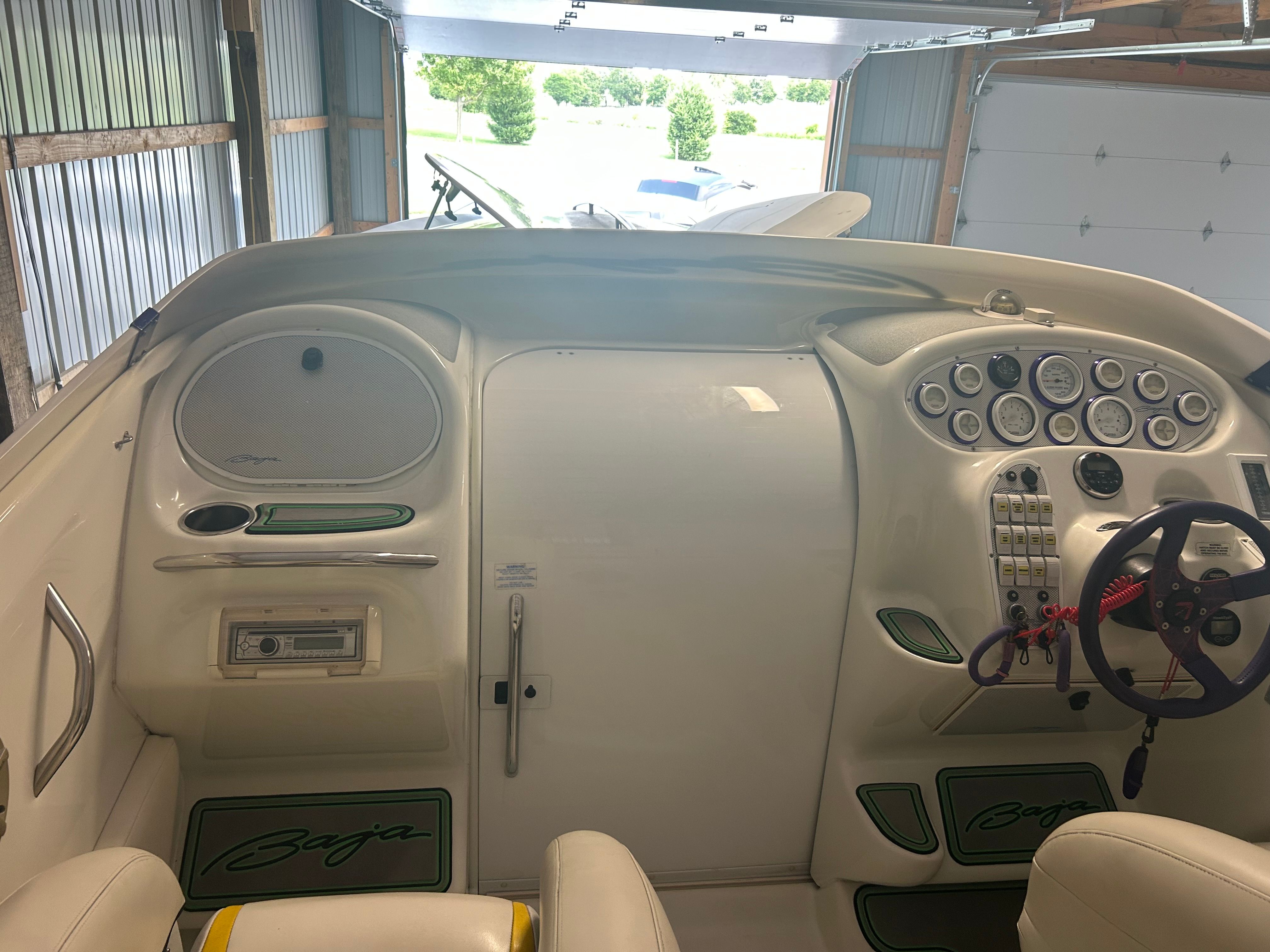 The cockpit of a 1996 Baja 302 with white and green accents.