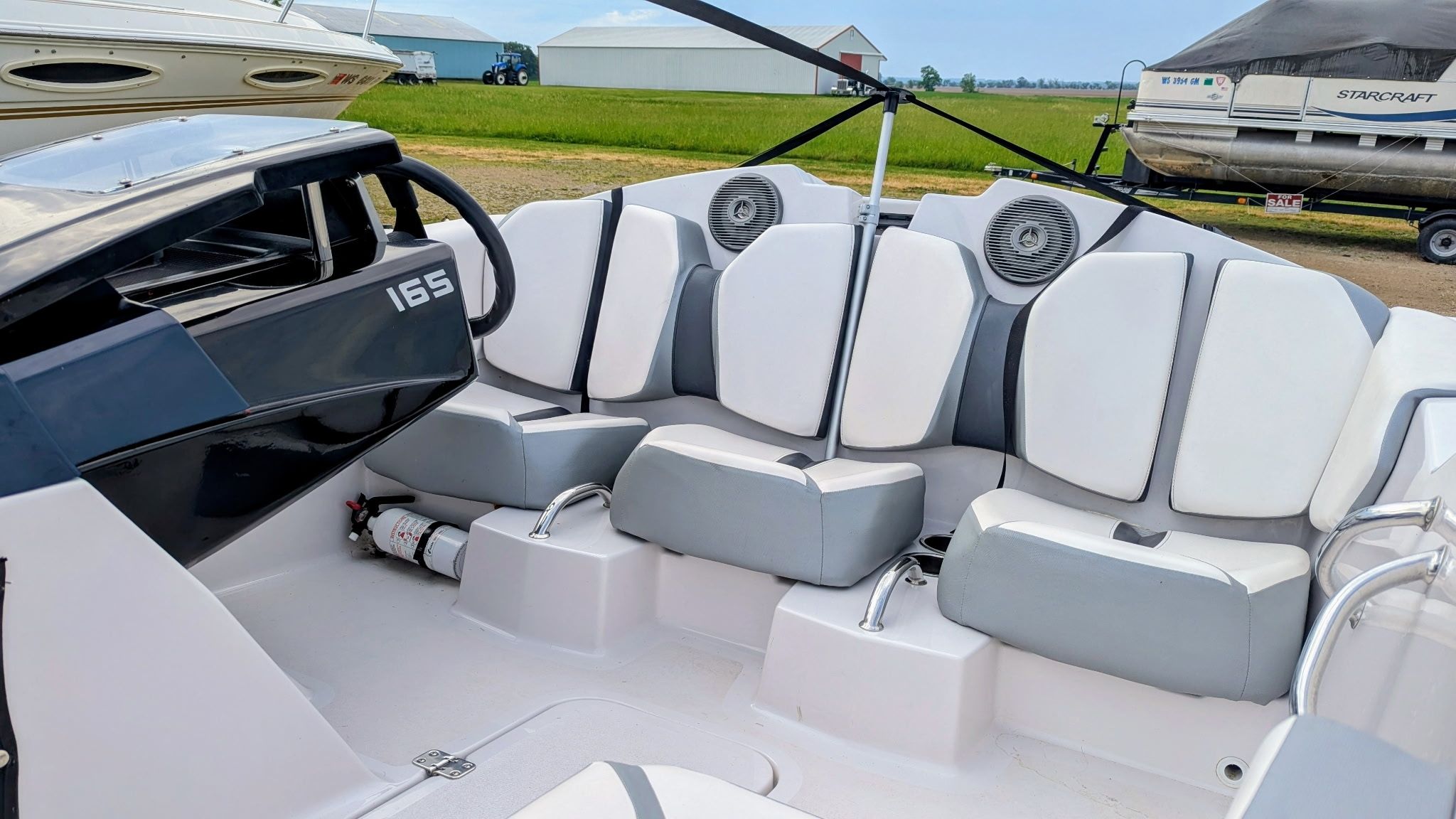 Interior of a 2017 Scarab 165 H.O. boat with white seating.