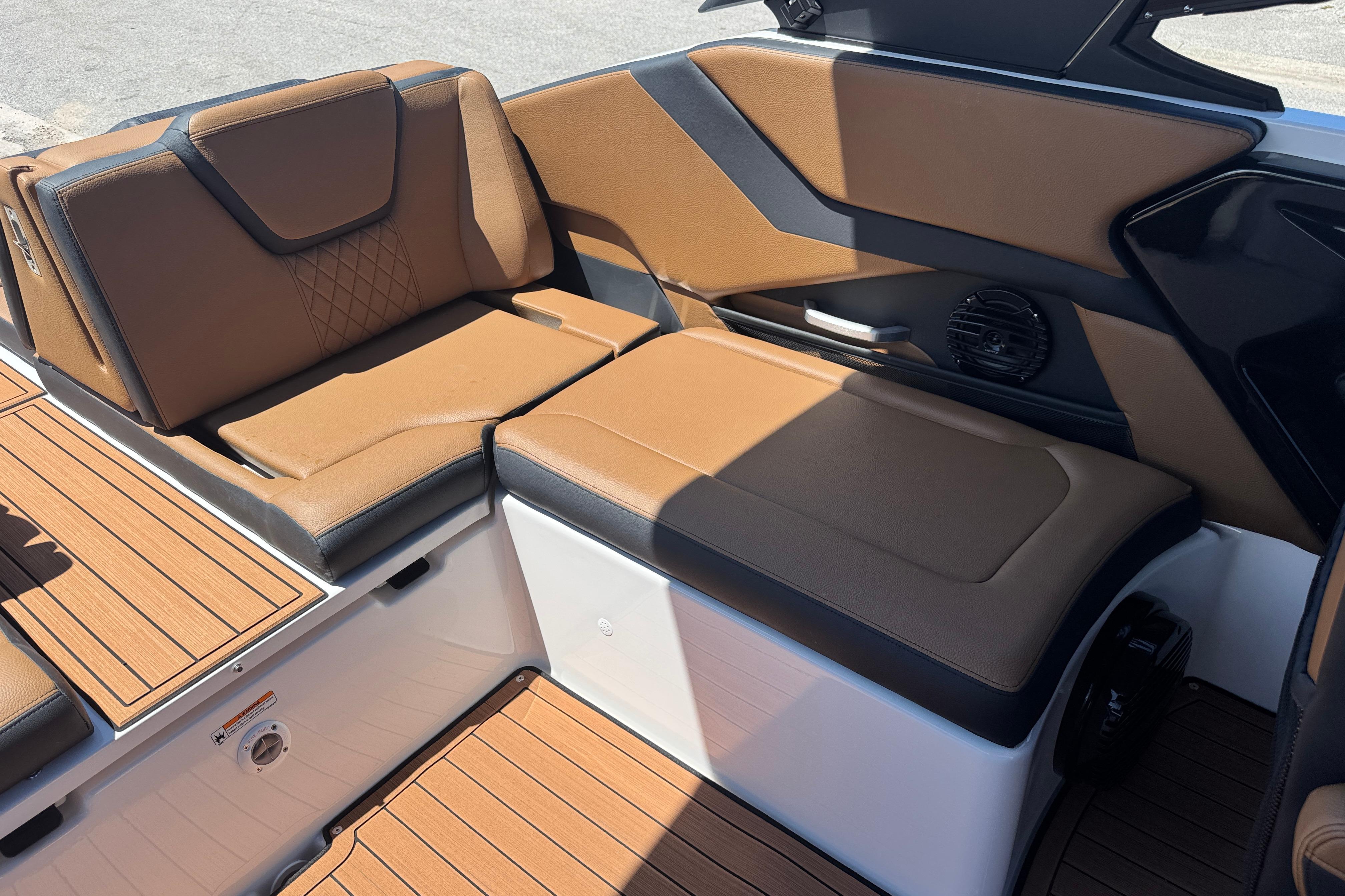 Luxurious seating on 2026 Yamaha Boats 252SD, featuring brown upholstery and sleek design.