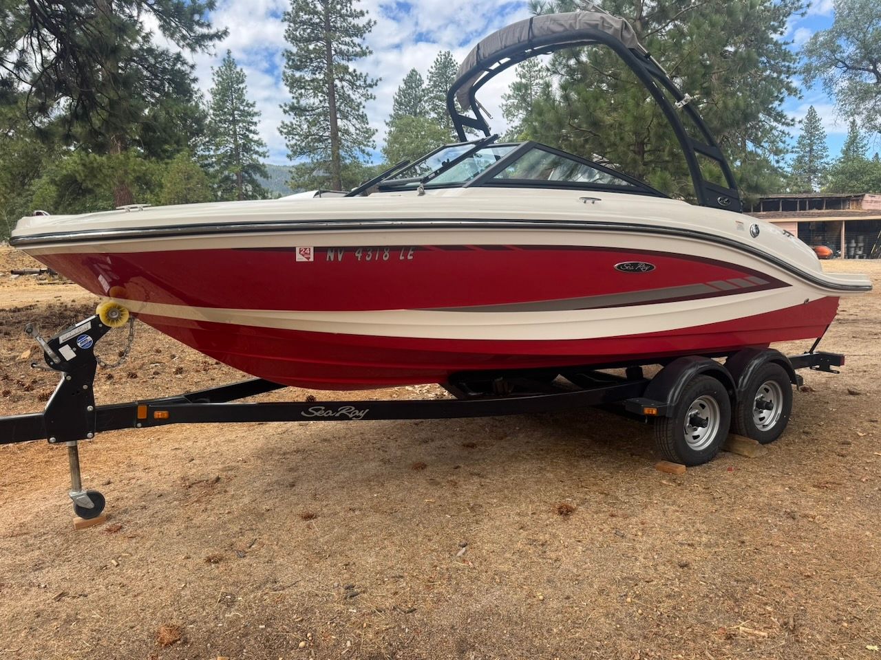 2016 Sea Ray SPX 190 Outboard on a trailer parked outdoors.
