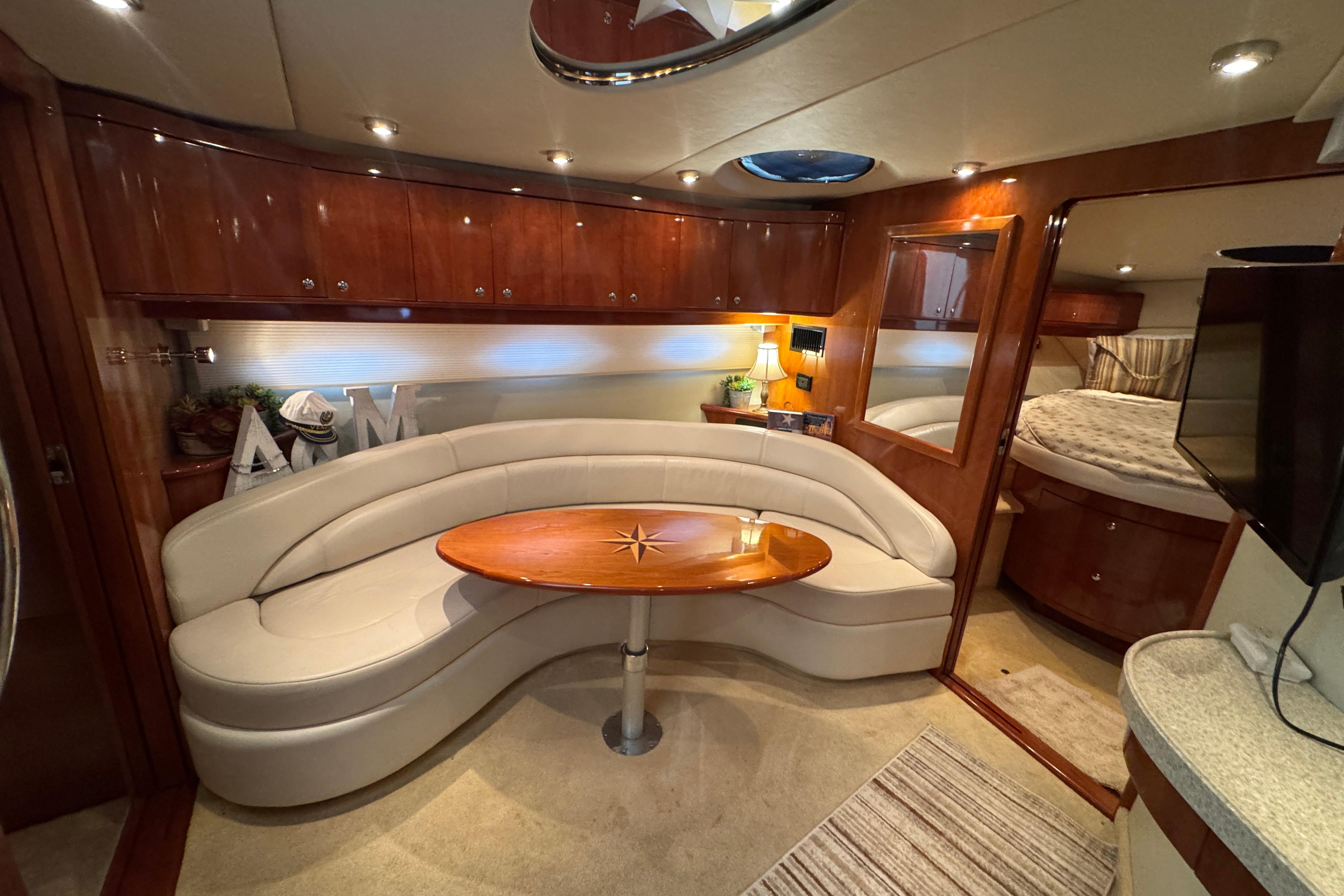 Luxurious interior of 2005 Regal Commodore 4260 yacht with elegant seating and wood finishes.