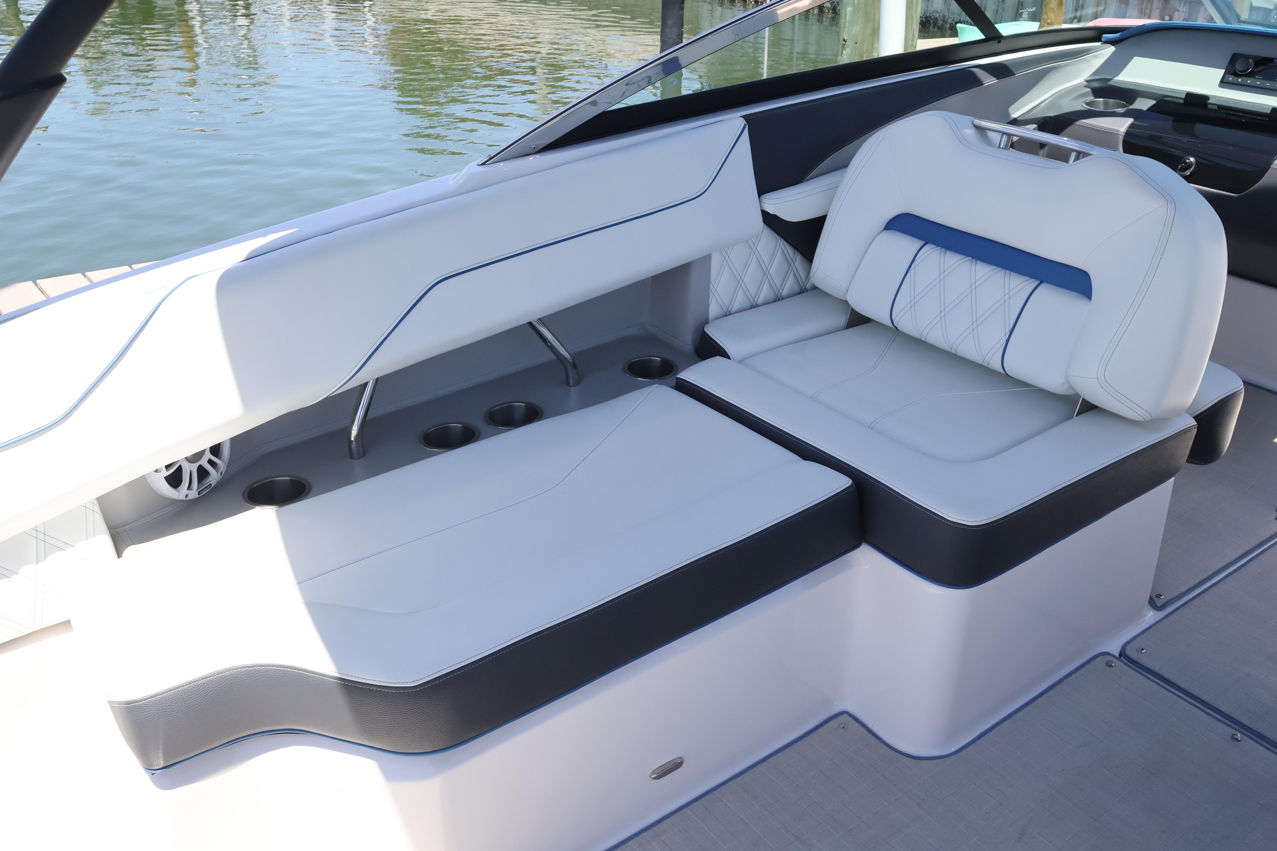 Luxurious seating on a 2020 Regal LX4 boat, featuring white and blue upholstery.