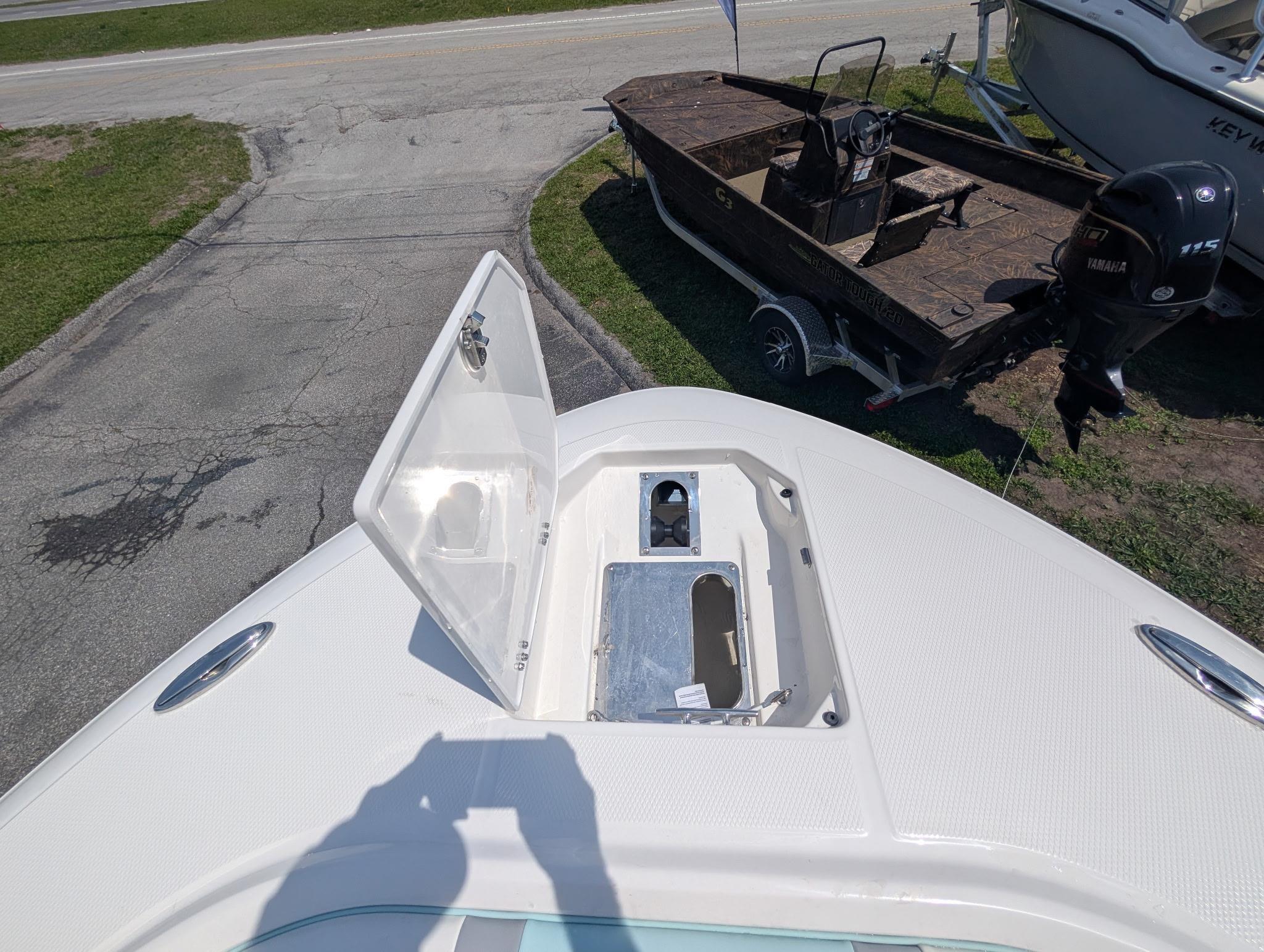 2025 Robalo R250 Center Console boat with open storage compartment on deck.