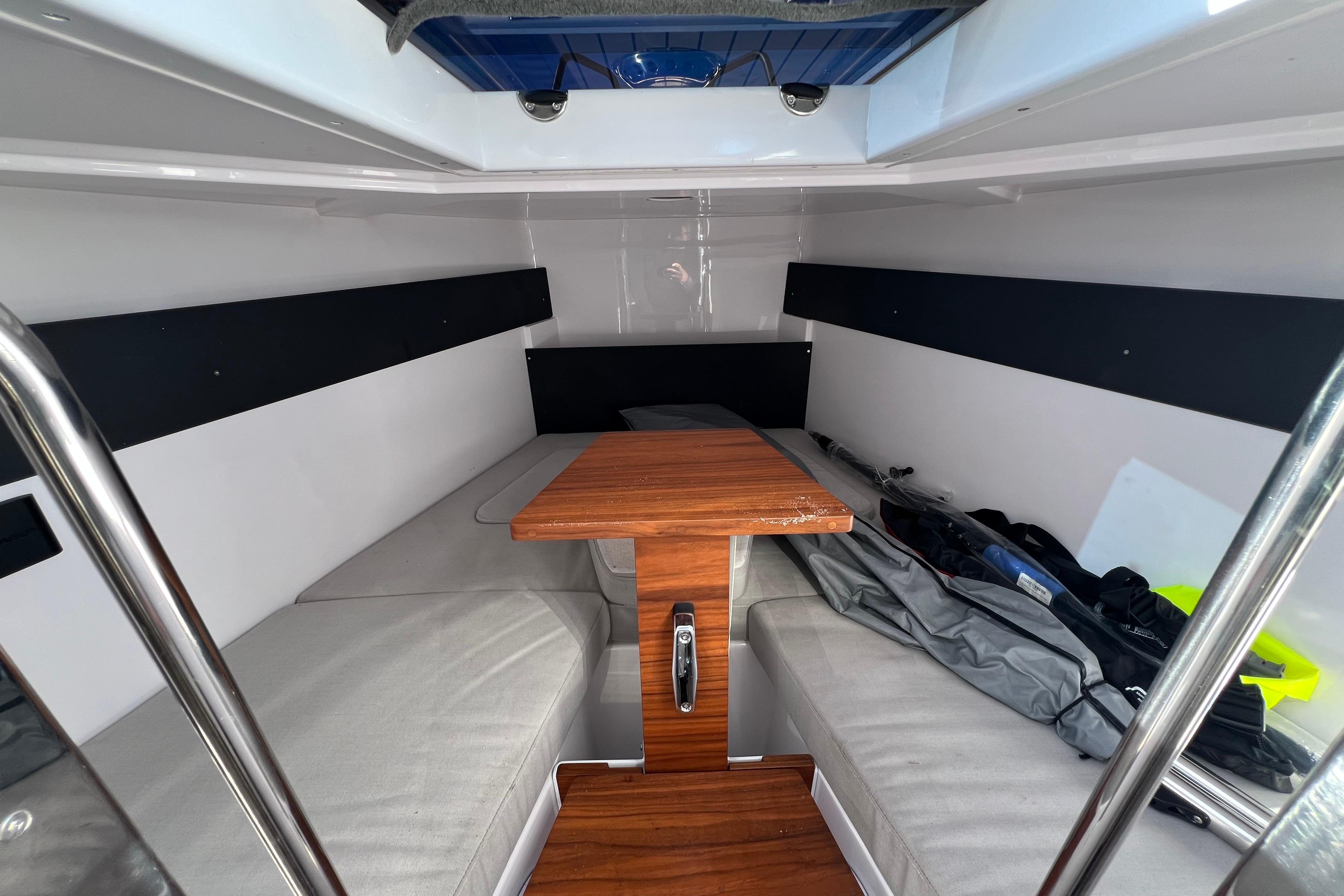 2024 XO Boats EXPLR 10 S Plus cabin interior with wooden table and seating.