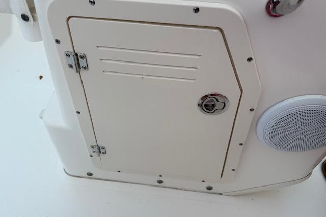 2016 Boston Whaler 150 Montauk boat compartment with speaker and secure latch.