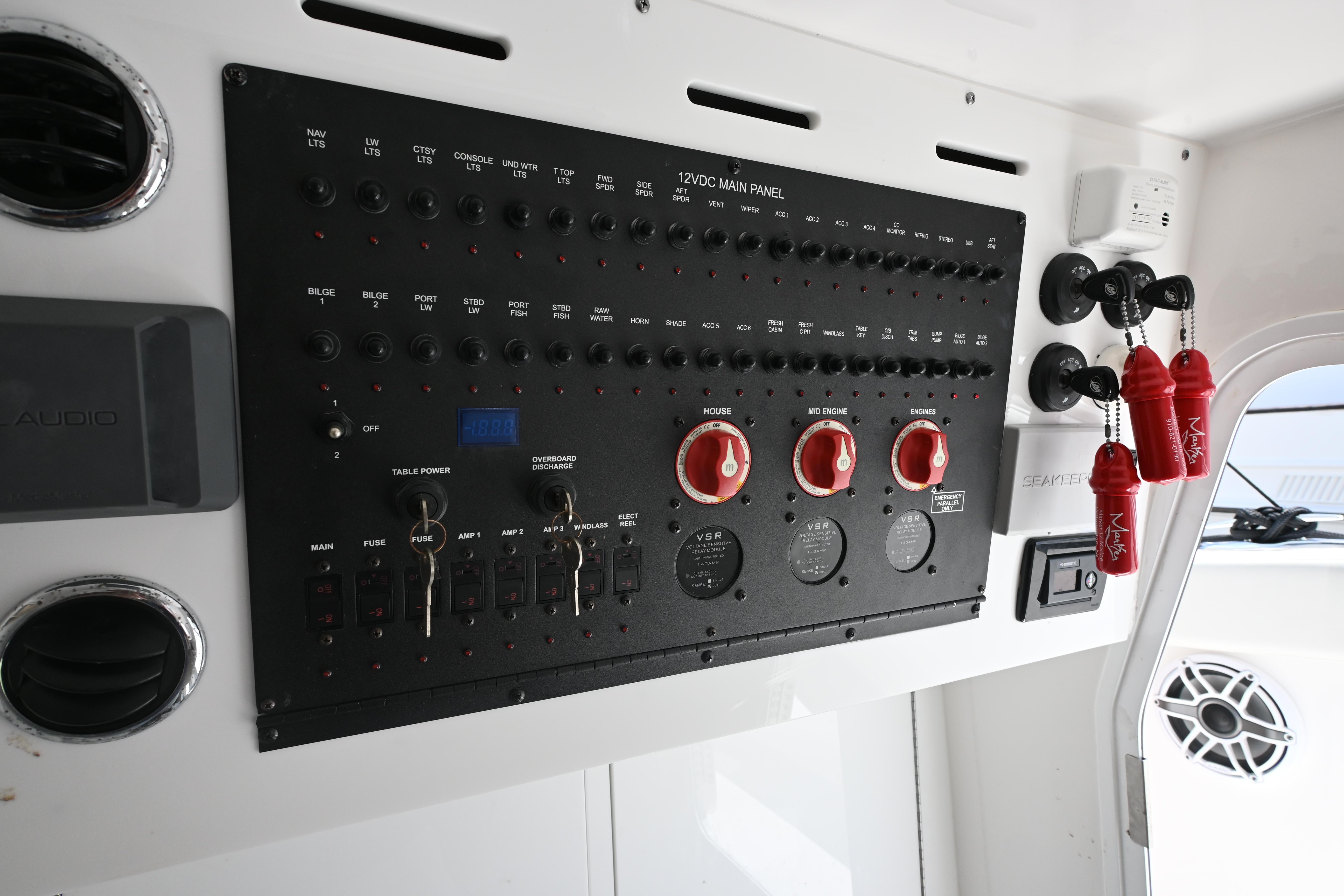 Control panel of 2023 Tidewater 380 CC Adventure boat with switches and gauges.