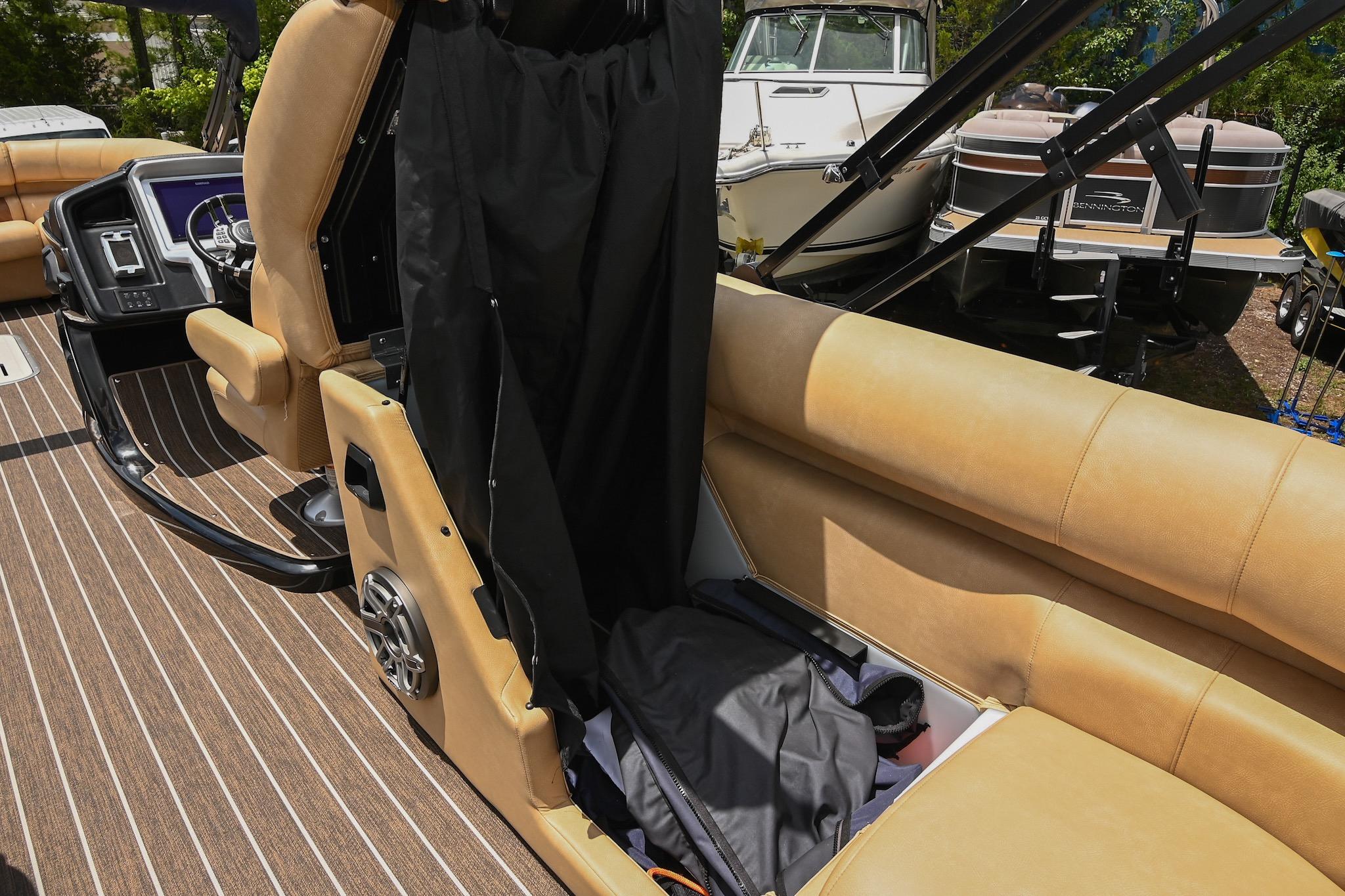 2023 Premier 270 Intrigue RF boat interior with tan seating and storage compartment.