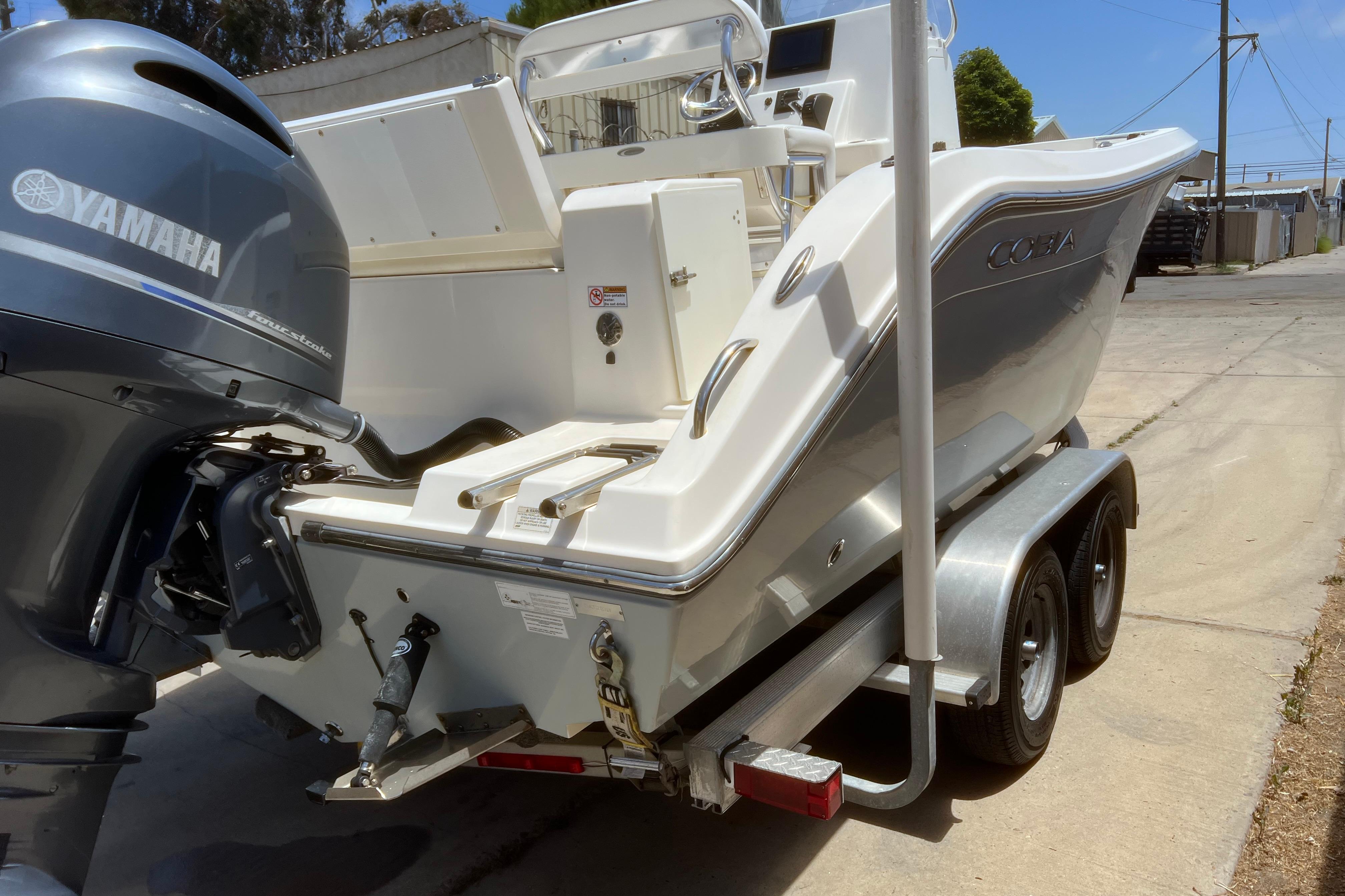 2018 Cobia 201 Center Console boat on trailer with Yamaha outboard motor.