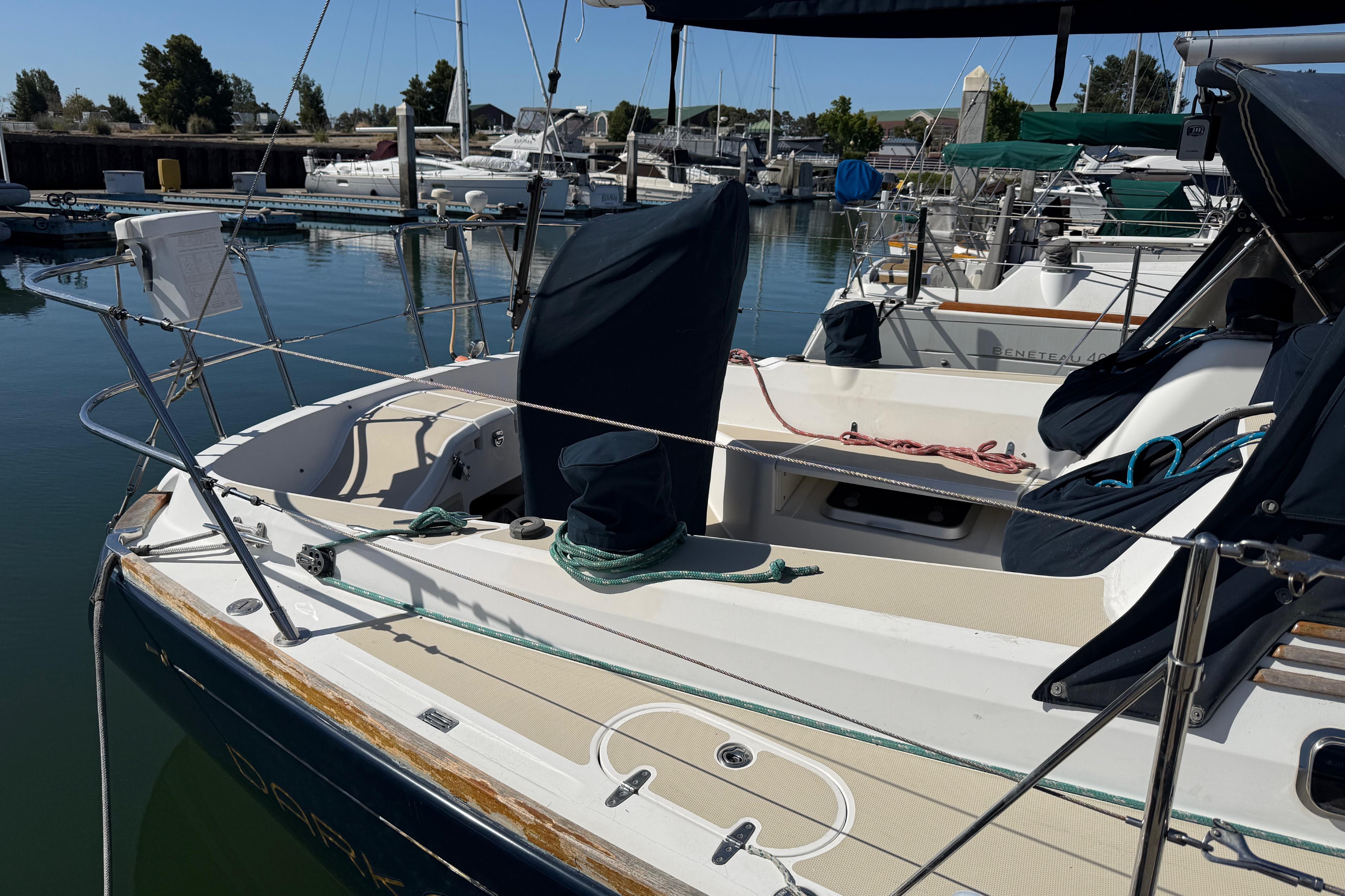 2004 Sabre 386 sailboat docked at marina, featuring spacious deck and mooring lines.