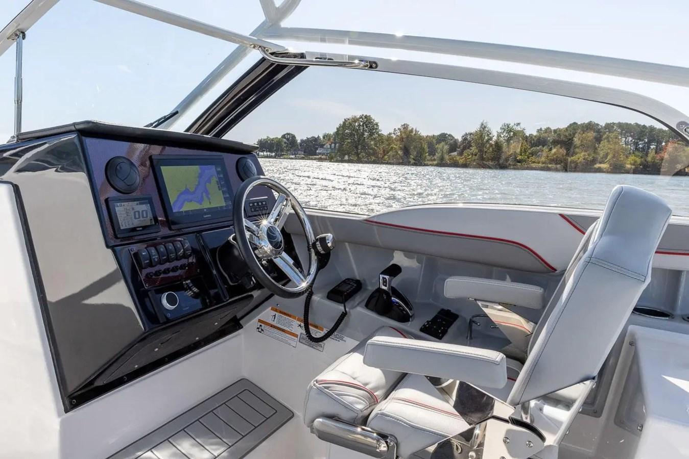 Interior of 2025 Solara S-250 DC boat with modern dashboard and steering wheel.