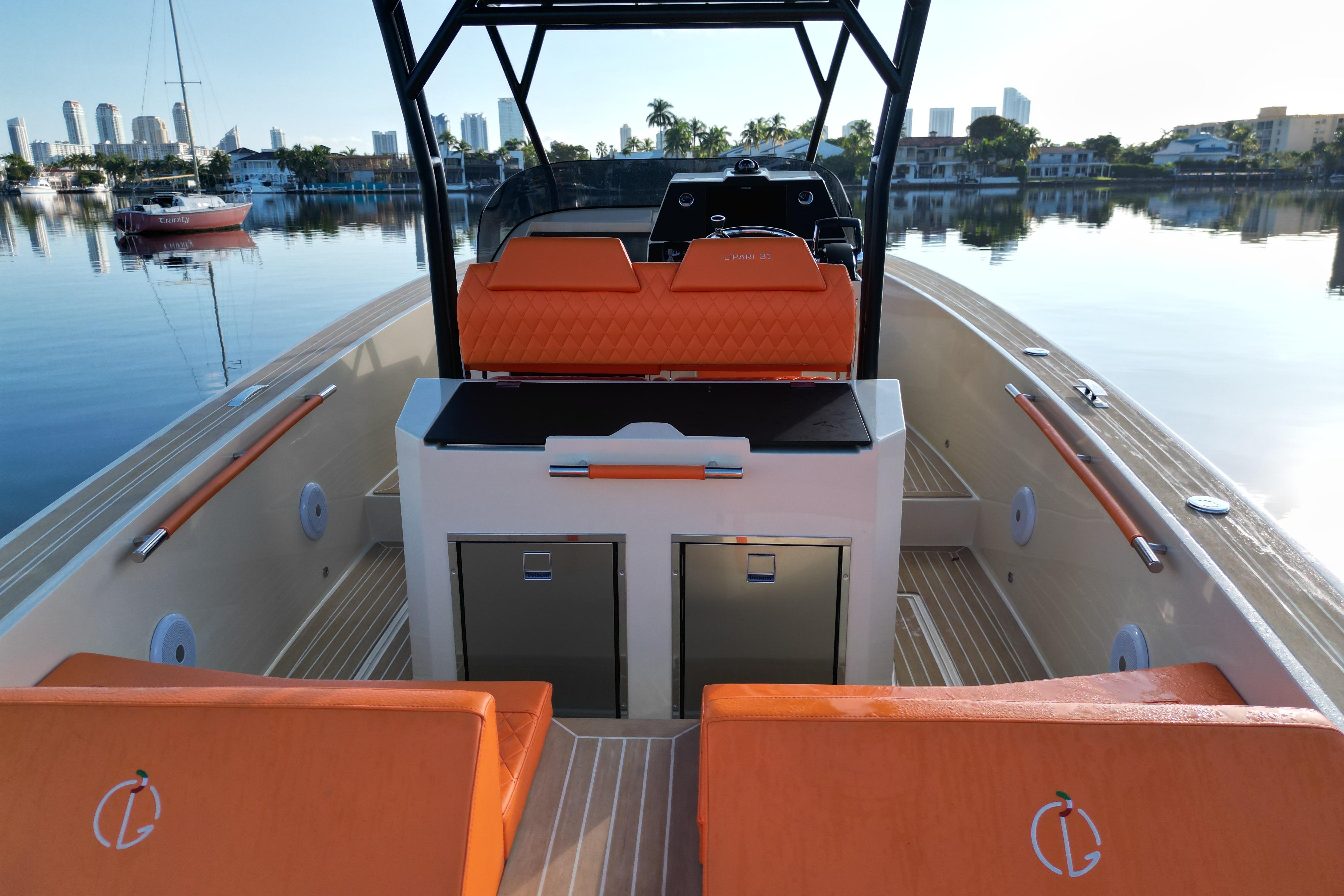2026 Lilybaeum Lipari 31 boat interior with orange seating, docked in a serene marina.