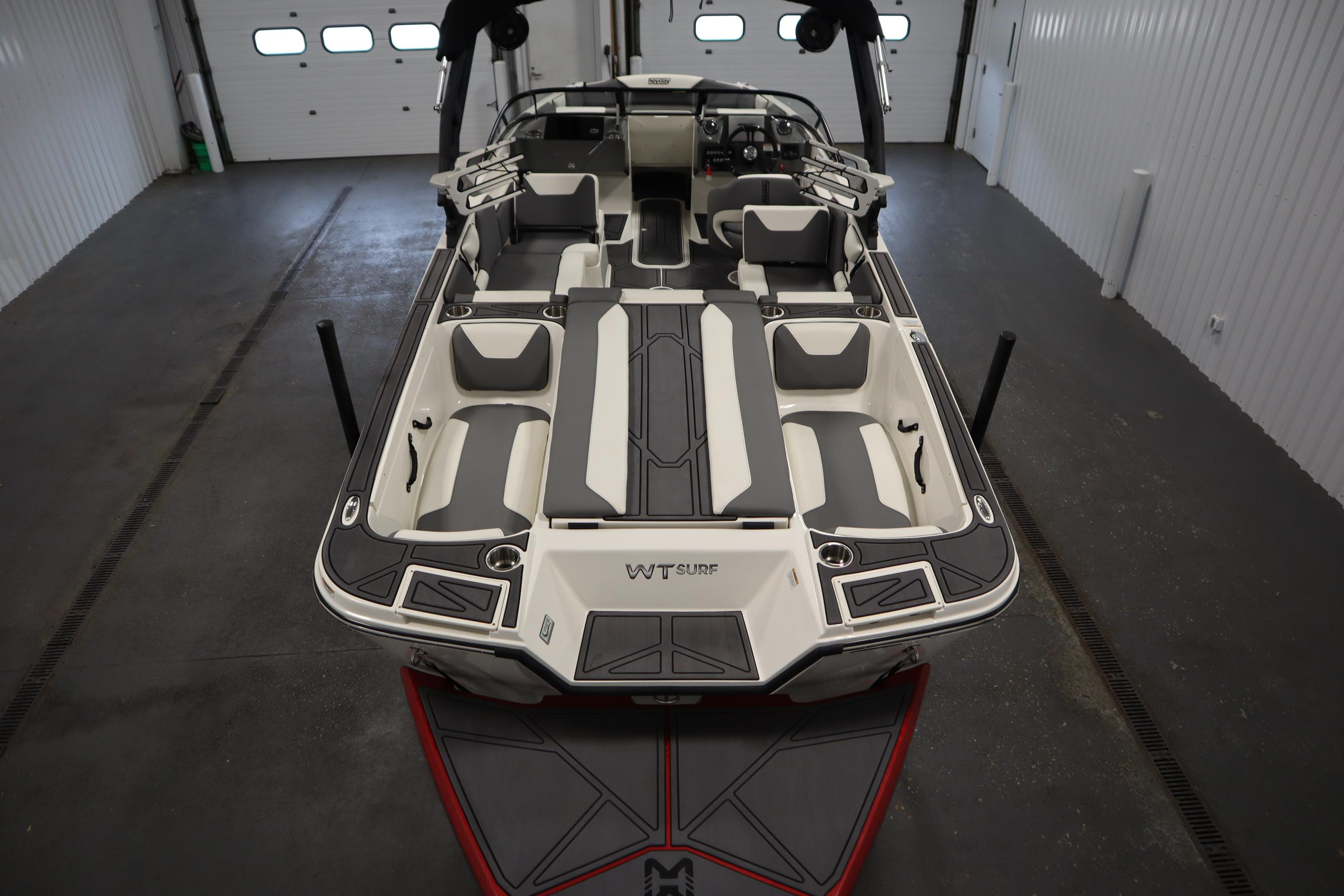 2023 Heyday WT Surf boat interior, showcasing sleek seating and modern design in a garage setting.