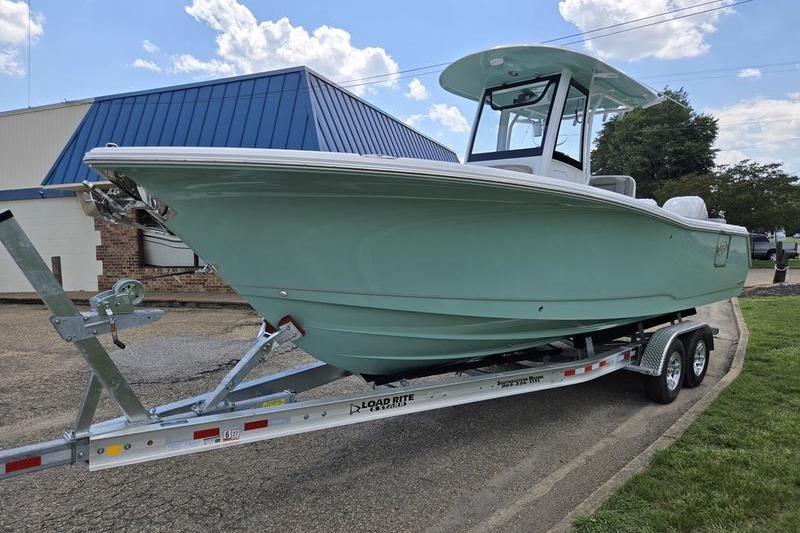 2027 Sea Hunt Ultra 275 SE boat on trailer, parked outdoors under a blue sky.