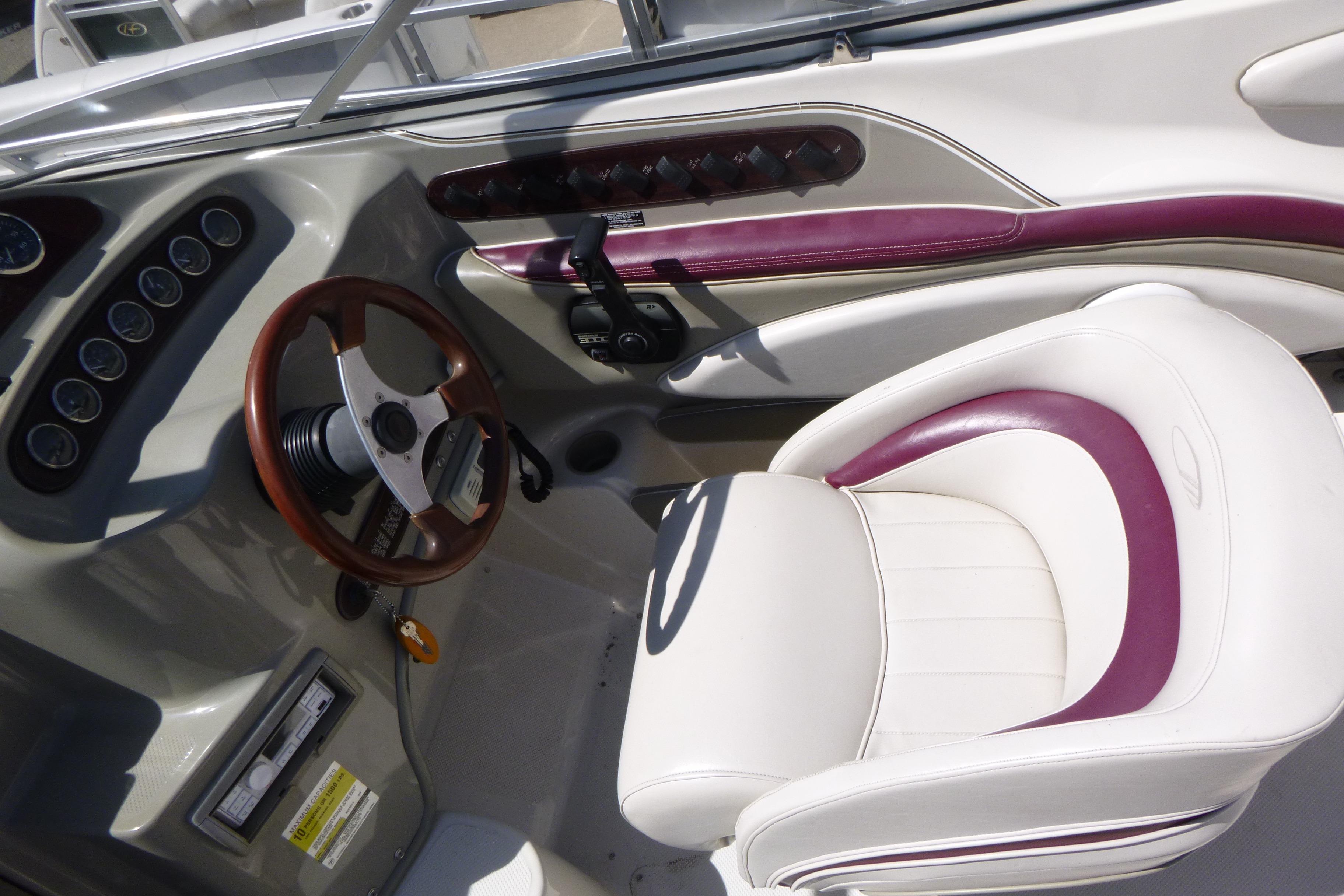 1998 Maxum 2300 SC boat interior with steering wheel and white seat.