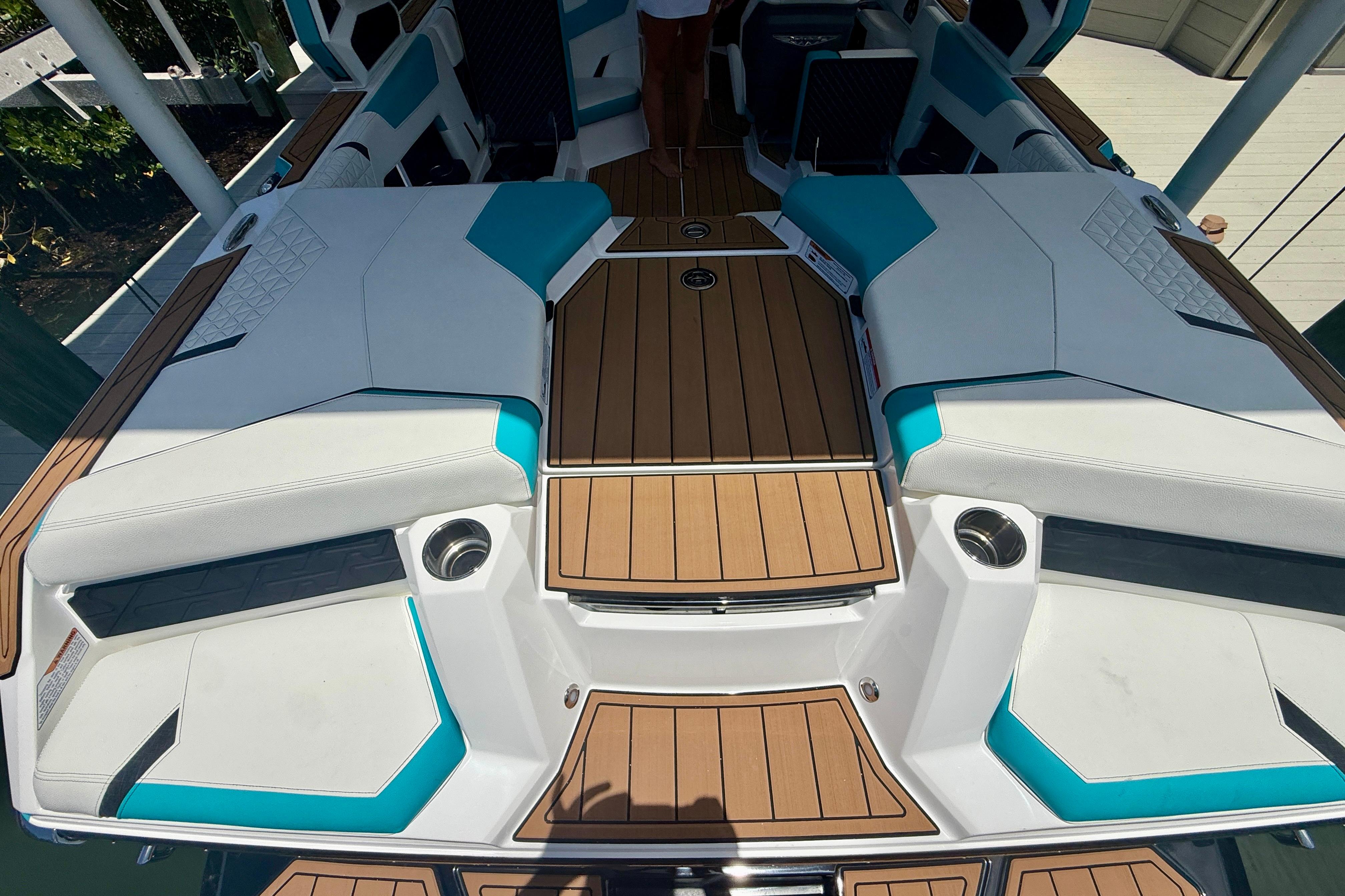 2024 Nautique Super Air Nautique GS20 boat interior with teak flooring and white seating.