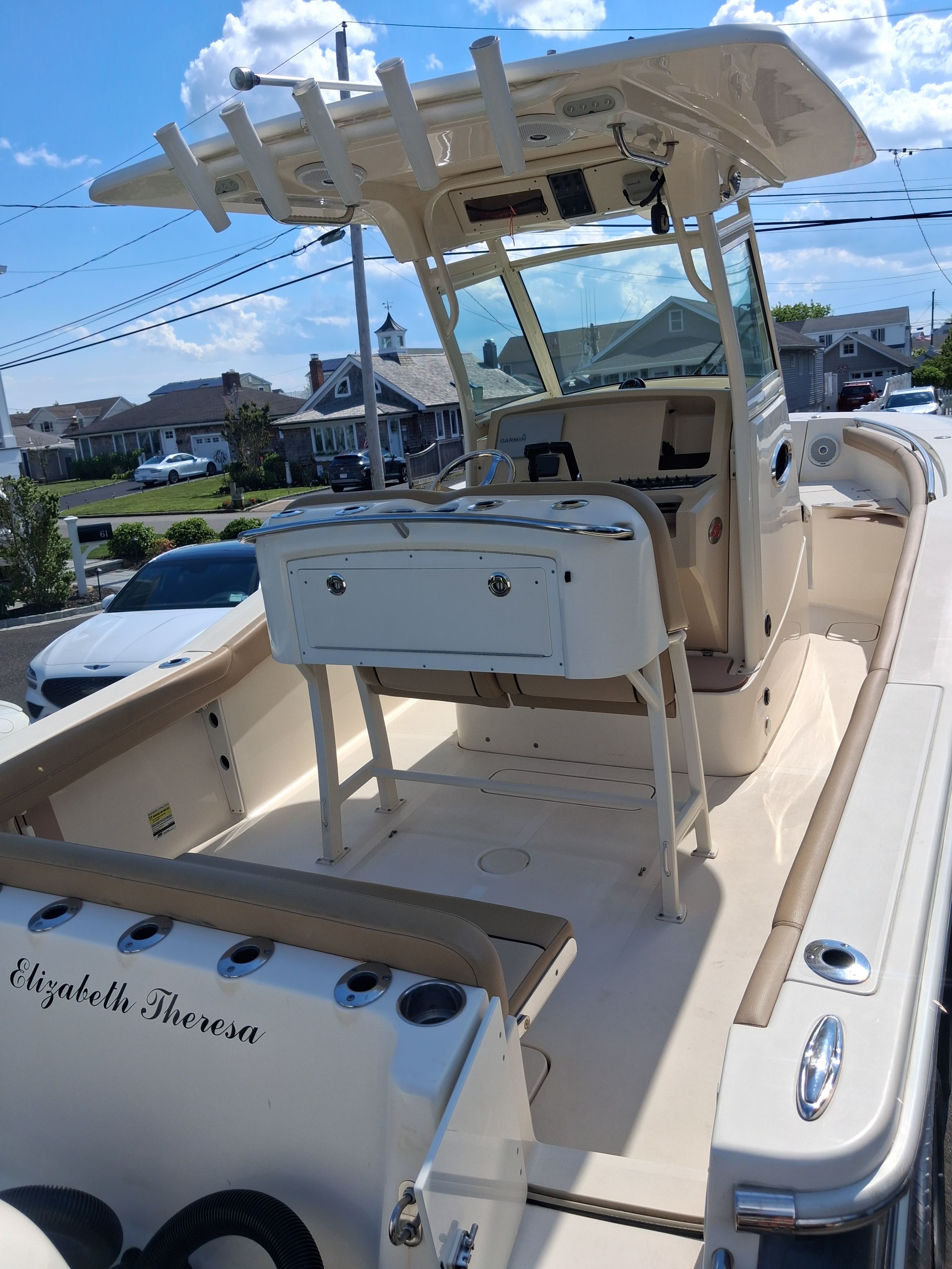 2018 Scout 255LXF boat on a trailer, sunny day.