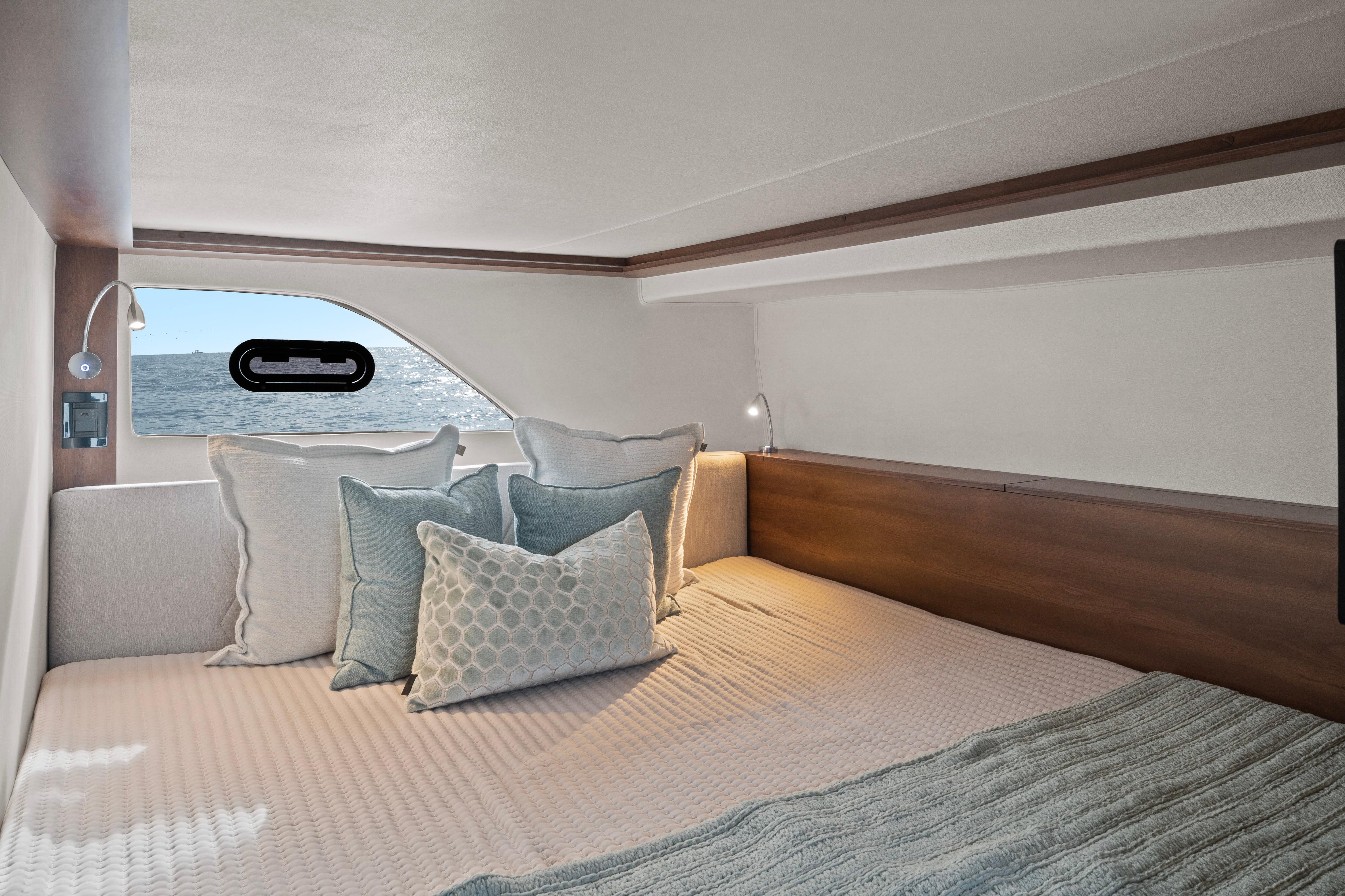 Cozy cabin interior of 2025 Valiatt 380GT yacht with ocean view window.