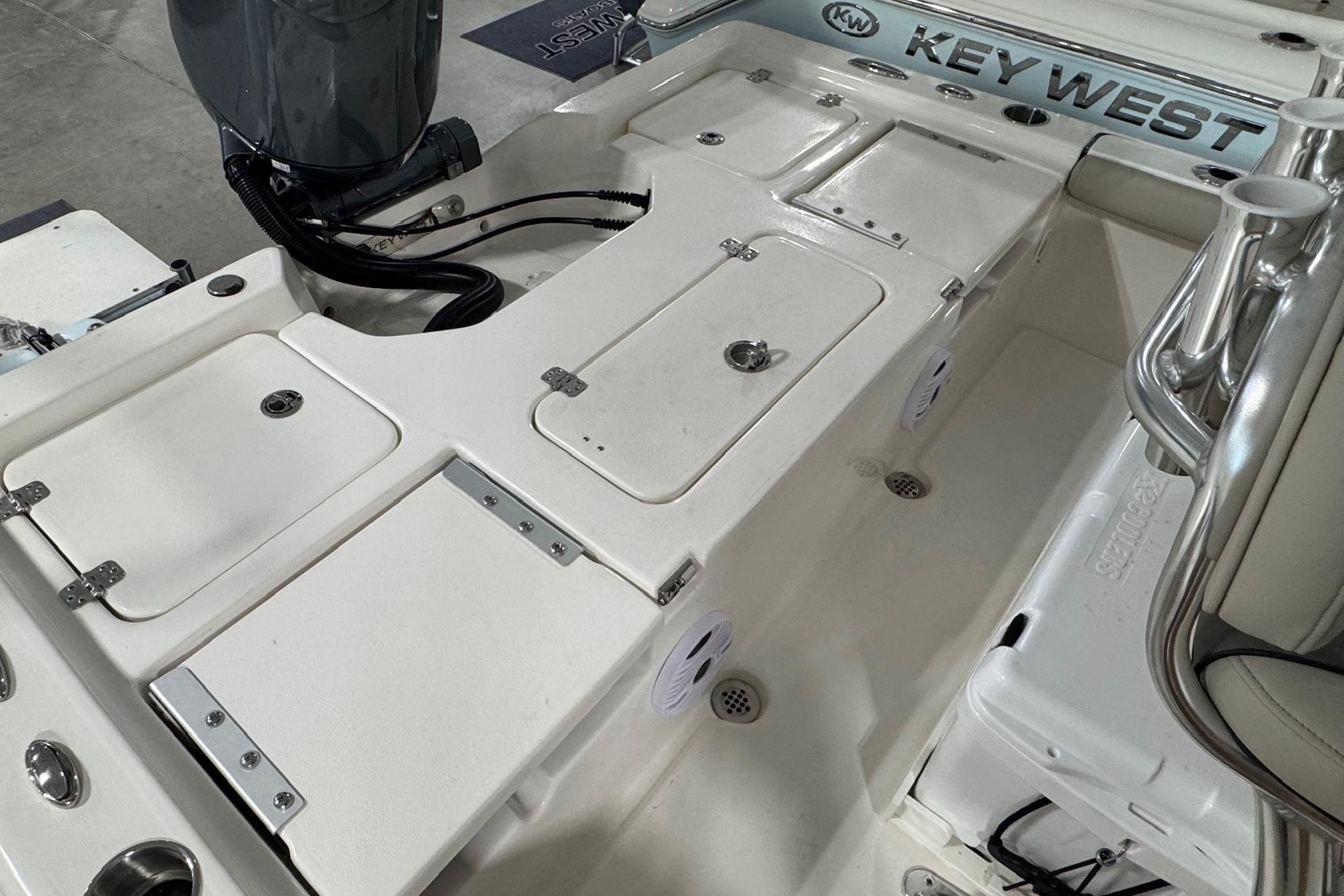 2026 Key West 210 Bay Reef boat interior with storage compartments and seating.