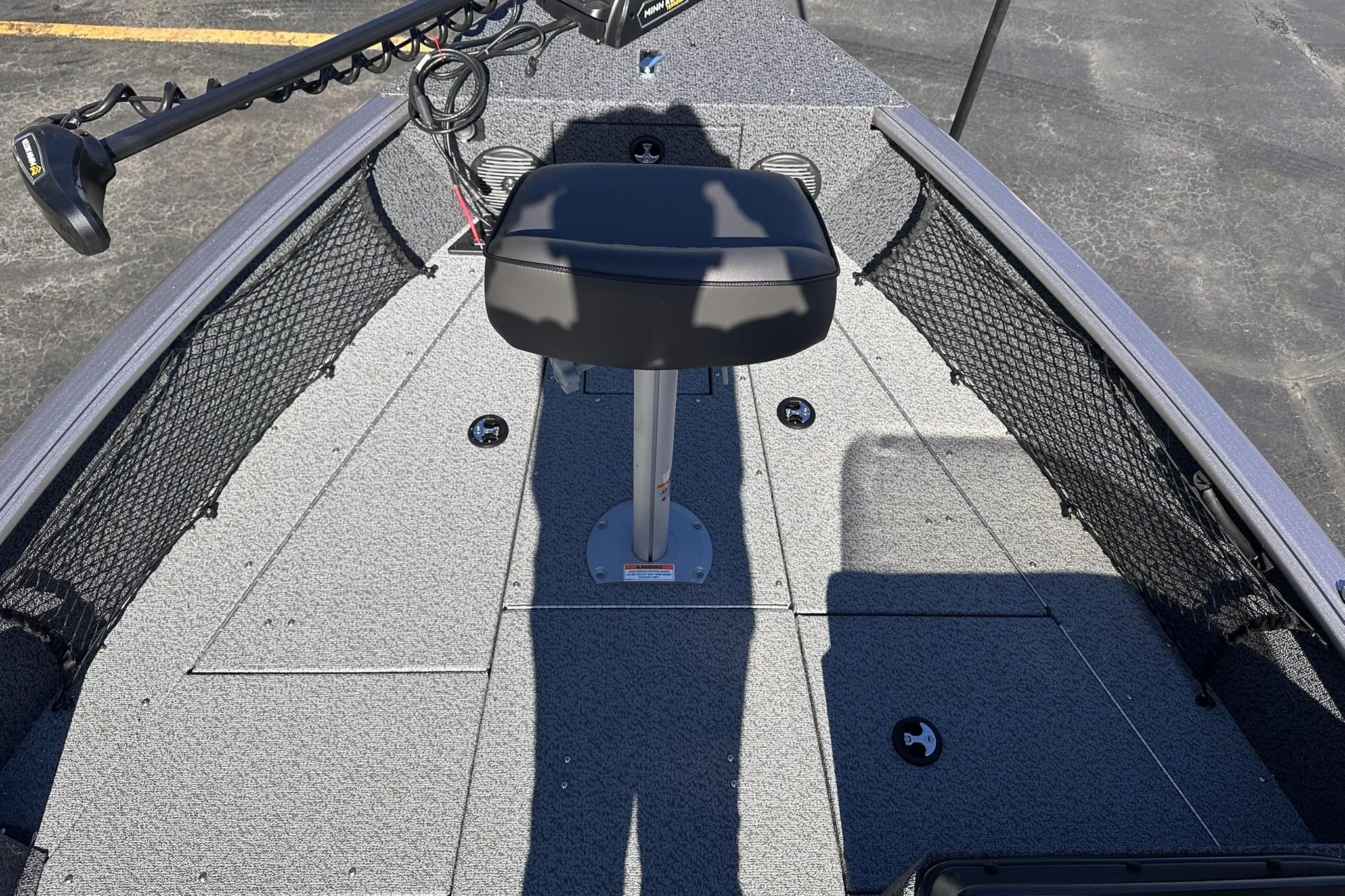 2026 Lund 1875 Impact XS SS boat interior with seating and storage compartments.