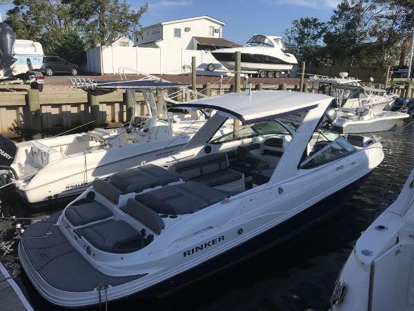 2020 Rinker 29QX BR boat docked at a marina with other boats.