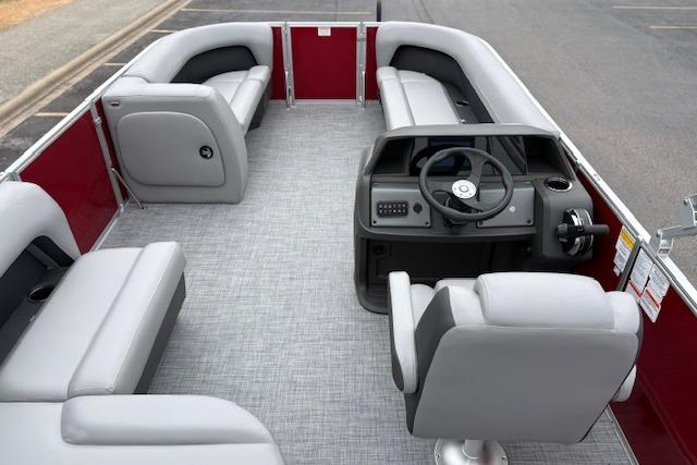 2026 Sun Tracker Party Barge 18 DLX interior with gray seating and steering console.