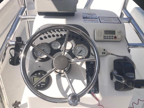 2011 Carolina Skiff 258 DLV boat dashboard with steering wheel and control instruments.