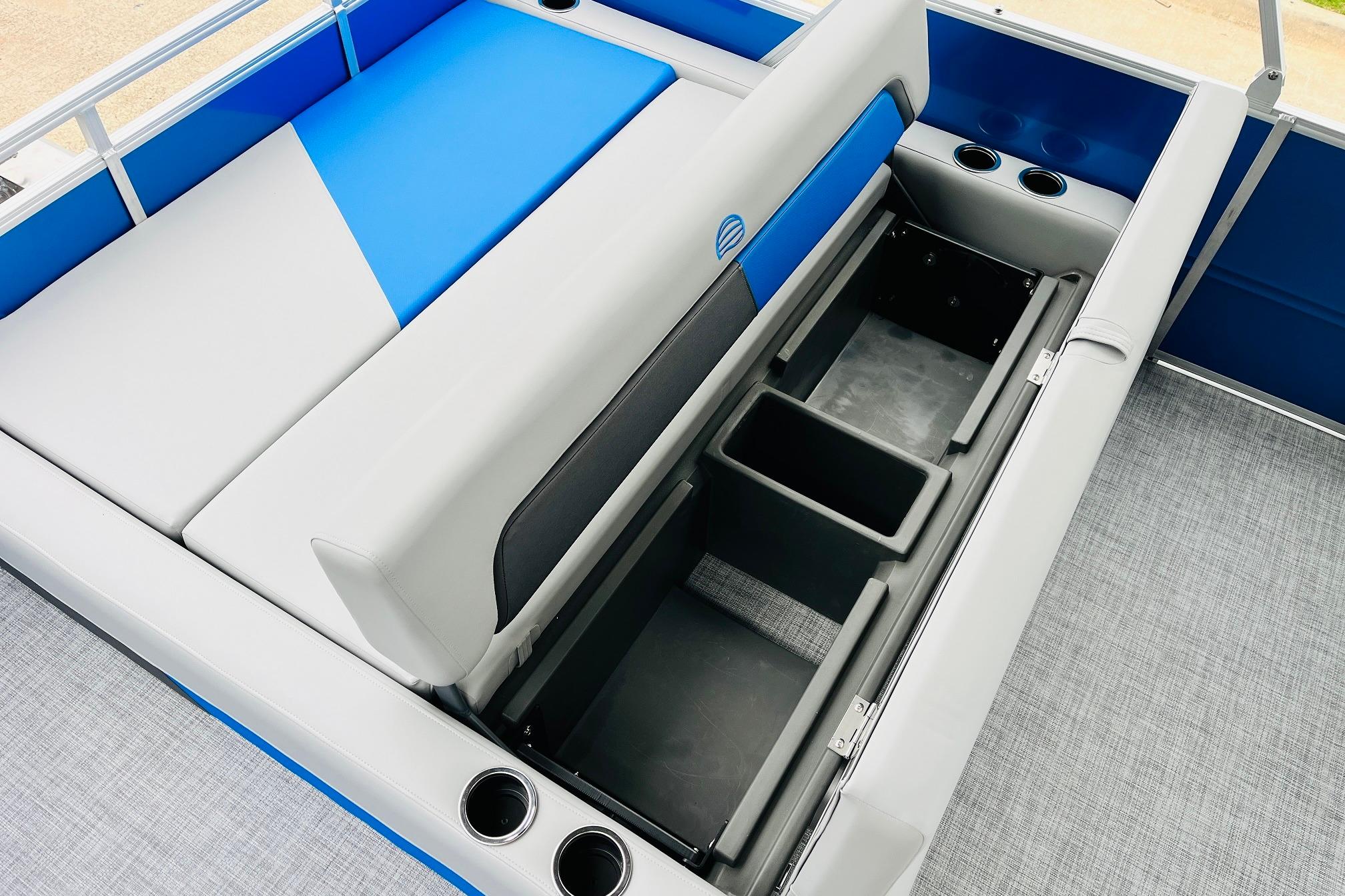 2026 Sun Tracker Party Barge 22 RF DLX interior with storage compartments and cup holders.