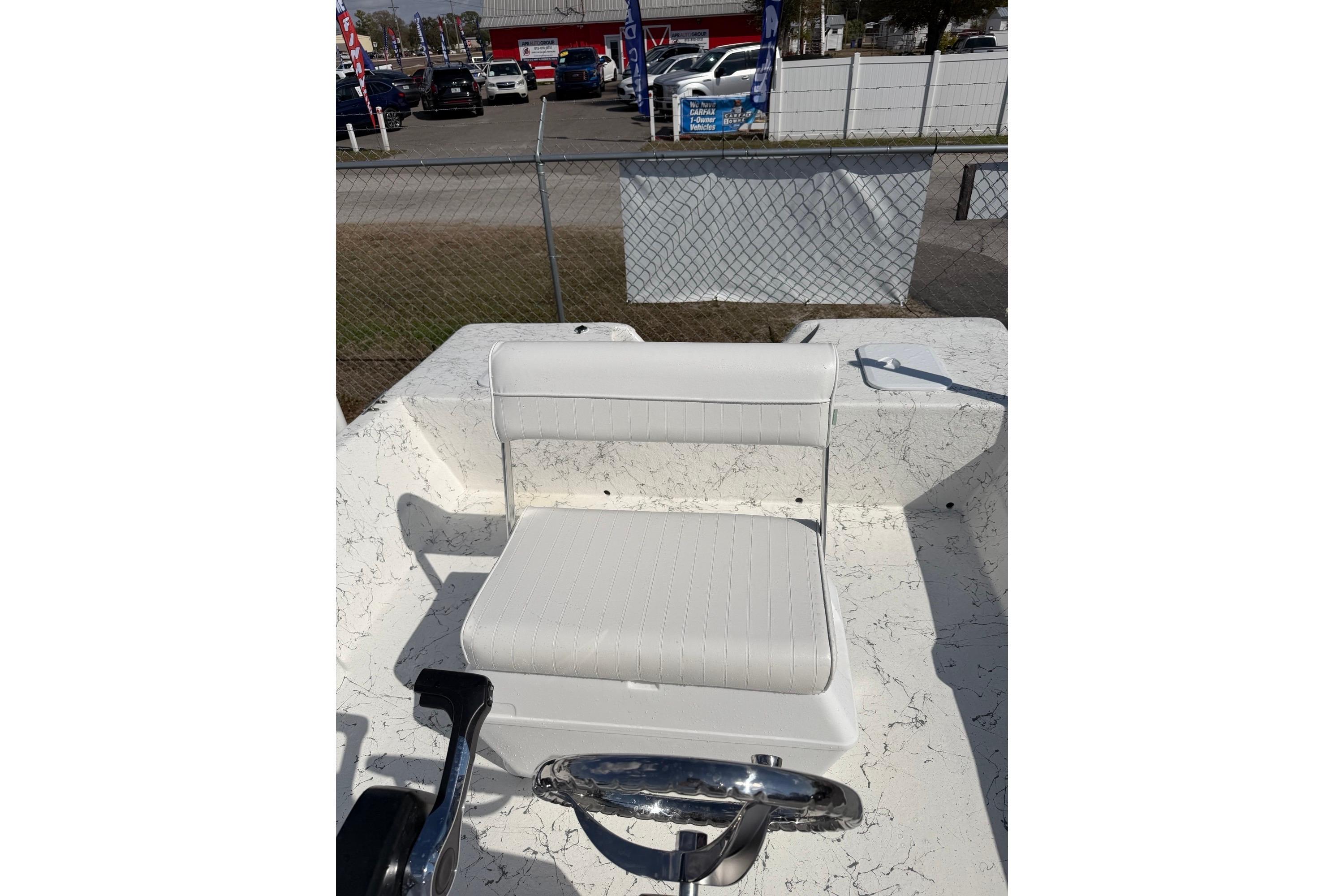 2027 Coastal Skiff 184 boat interior with white seating and steering wheel.