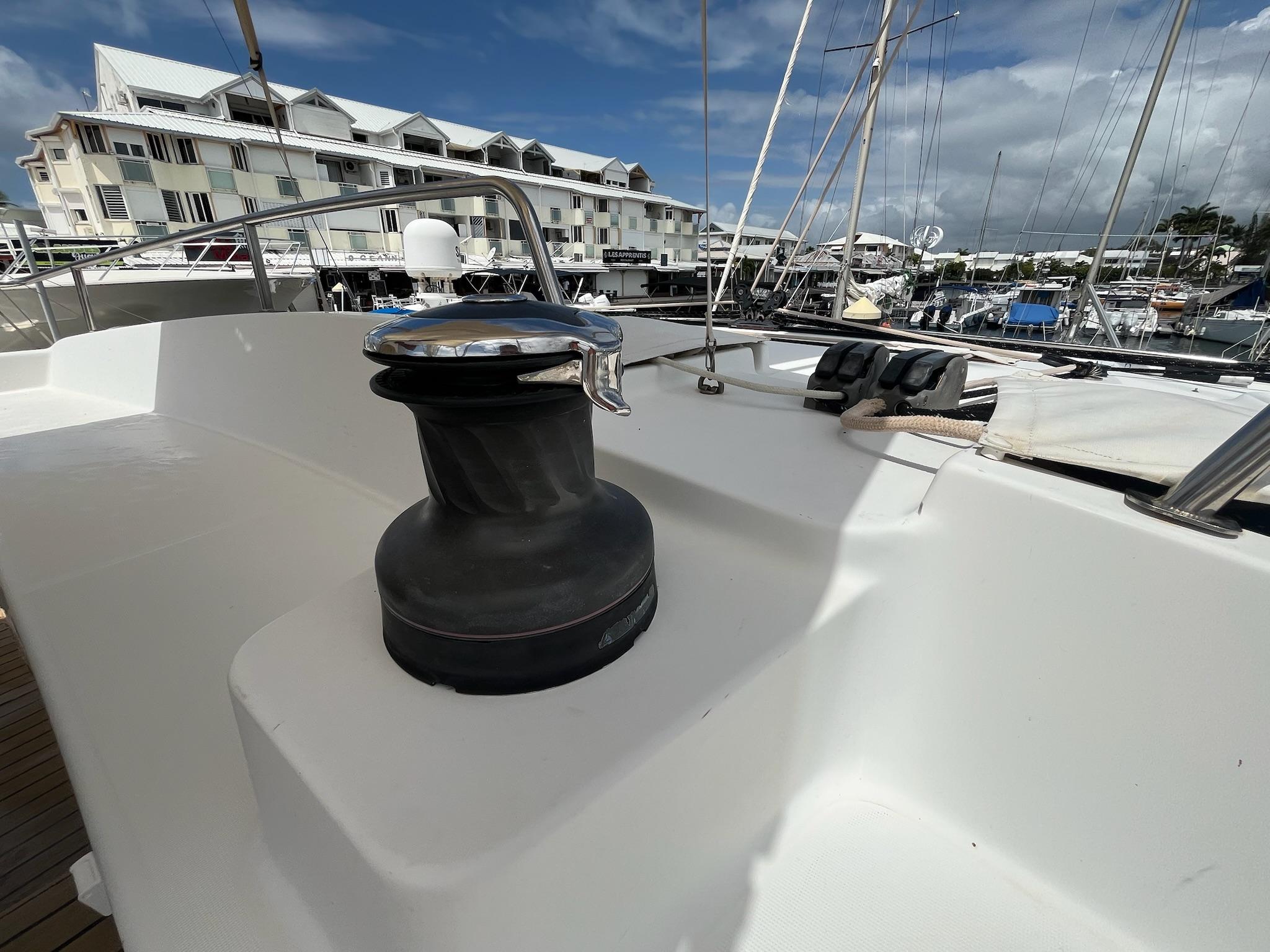 2009 Lagoon 440 yacht deck with winch, docked in marina.