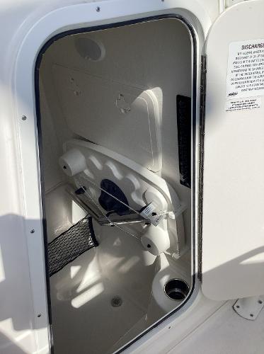 2022 Sailfish 220 CC storage compartment with open door, showcasing interior space.