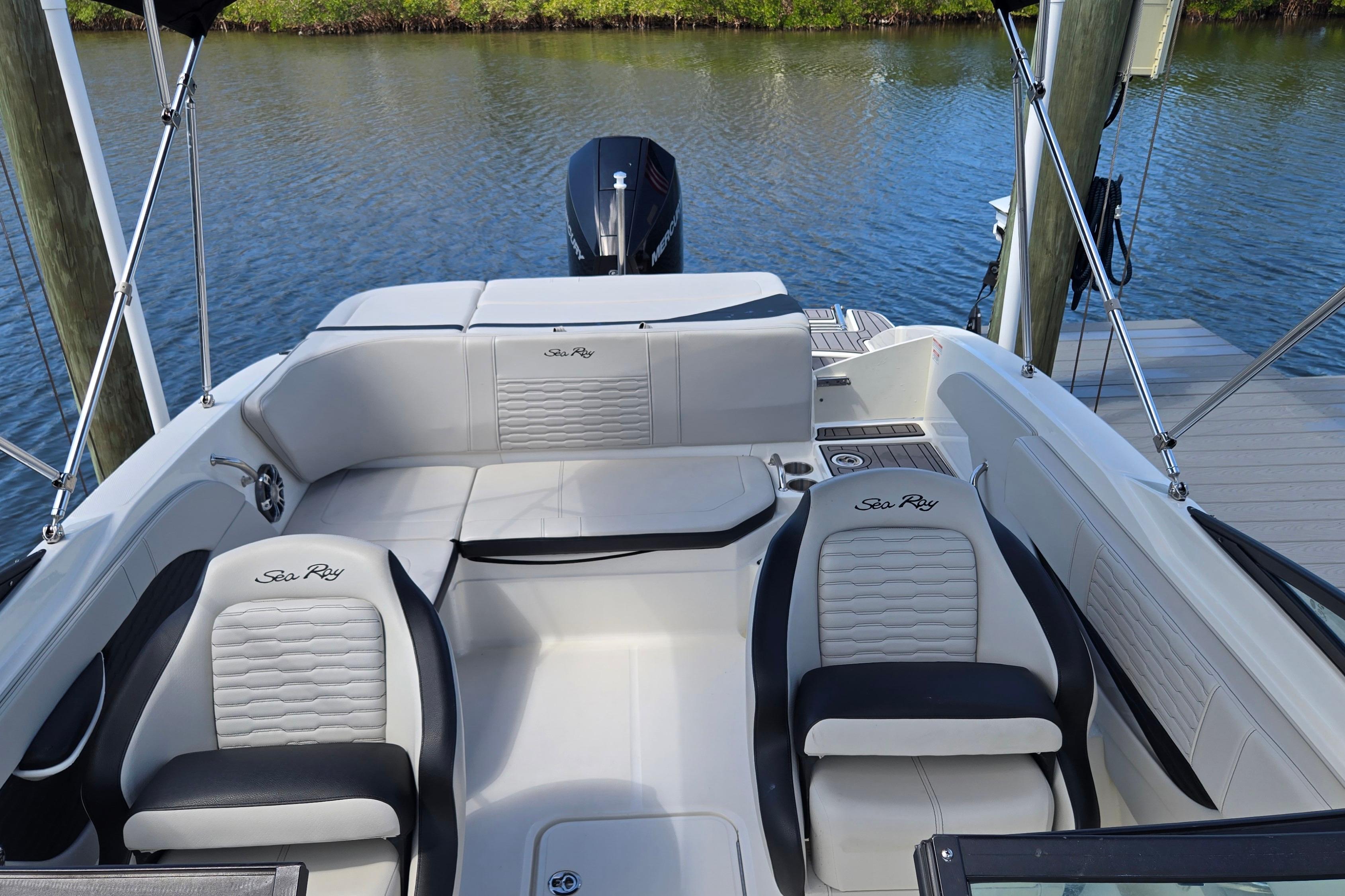 2023 Sea Ray SPX 210 boat interior with stylish seating and water backdrop.