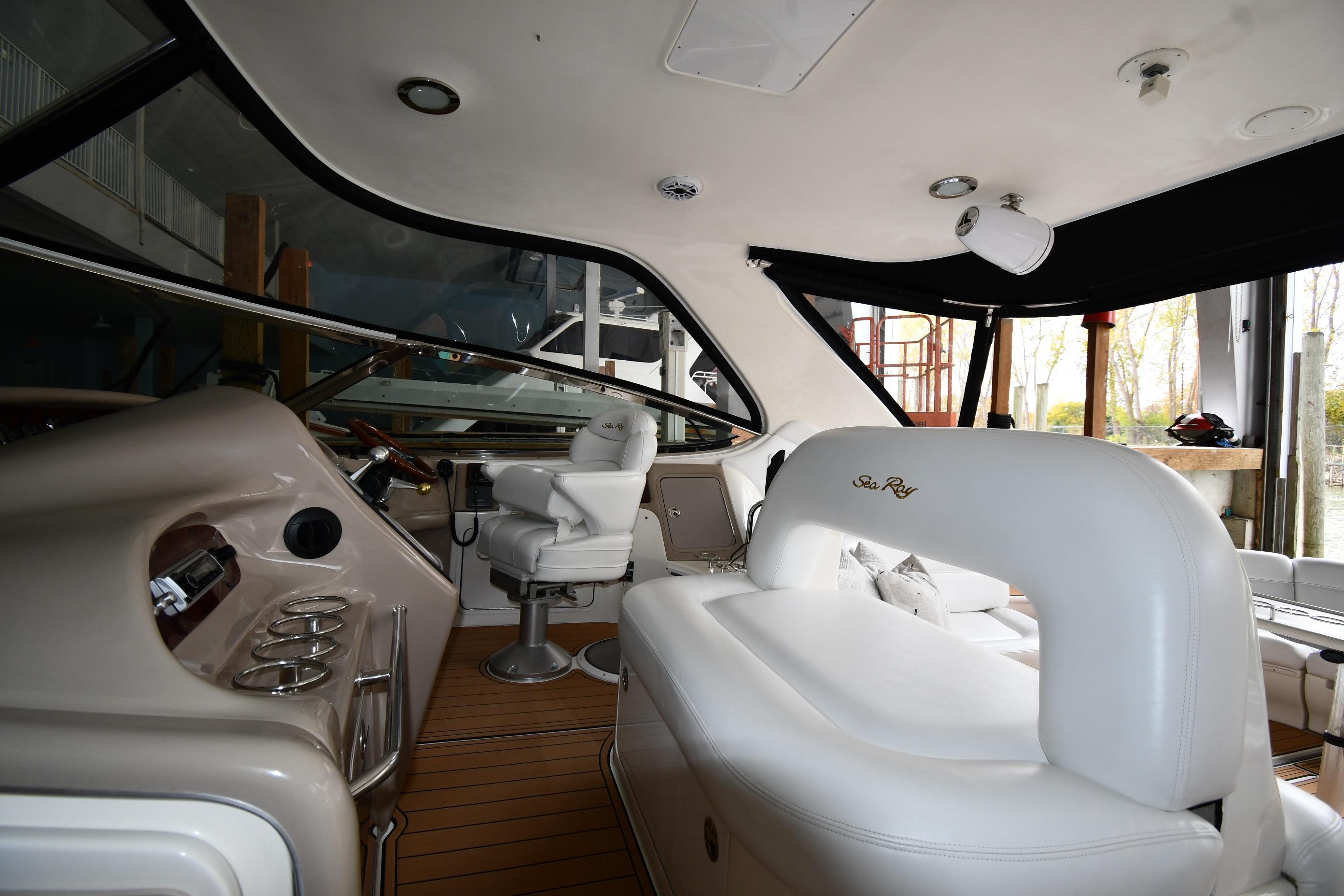 Interior of 2001 Sea Ray 540 Sundancer yacht with luxurious seating and helm.
