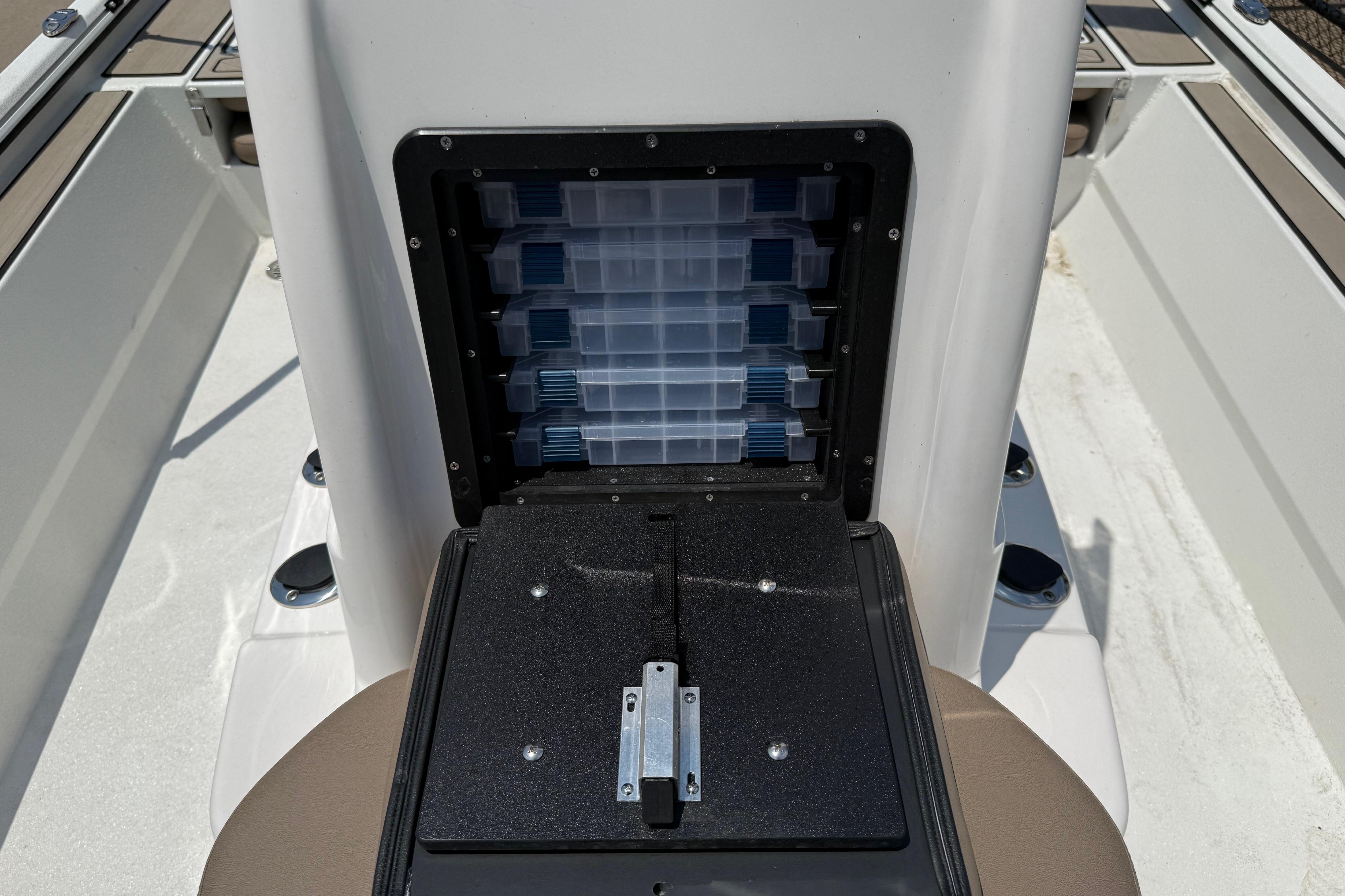 Storage compartment on 2025 Avid 22 Recon boat, featuring organized tackle boxes.
