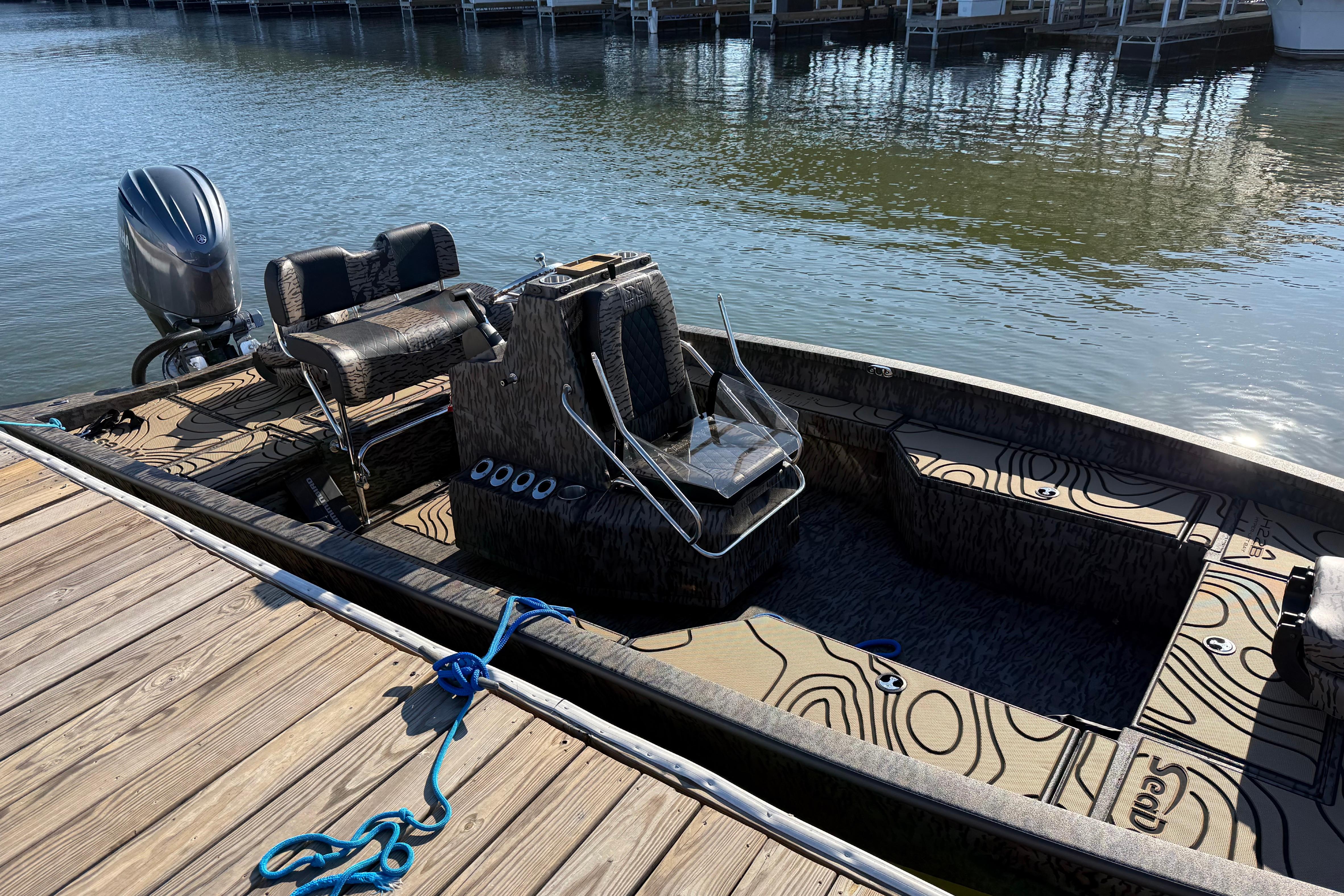 2025 Xpress H22B Bay boat docked, featuring sleek design and modern seating.