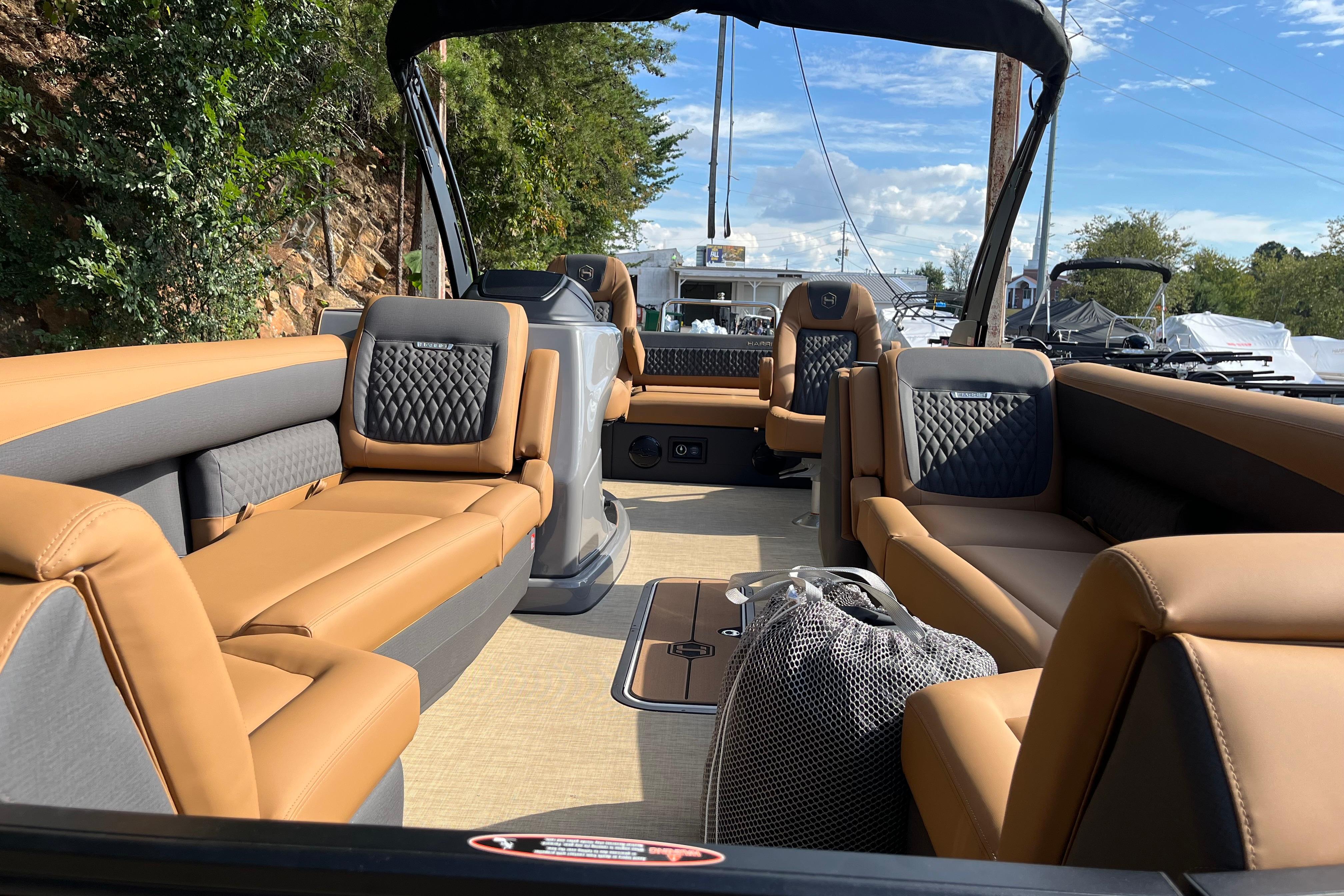 2025 Harris Sunliner 250 boat interior with luxurious tan seating and modern design.