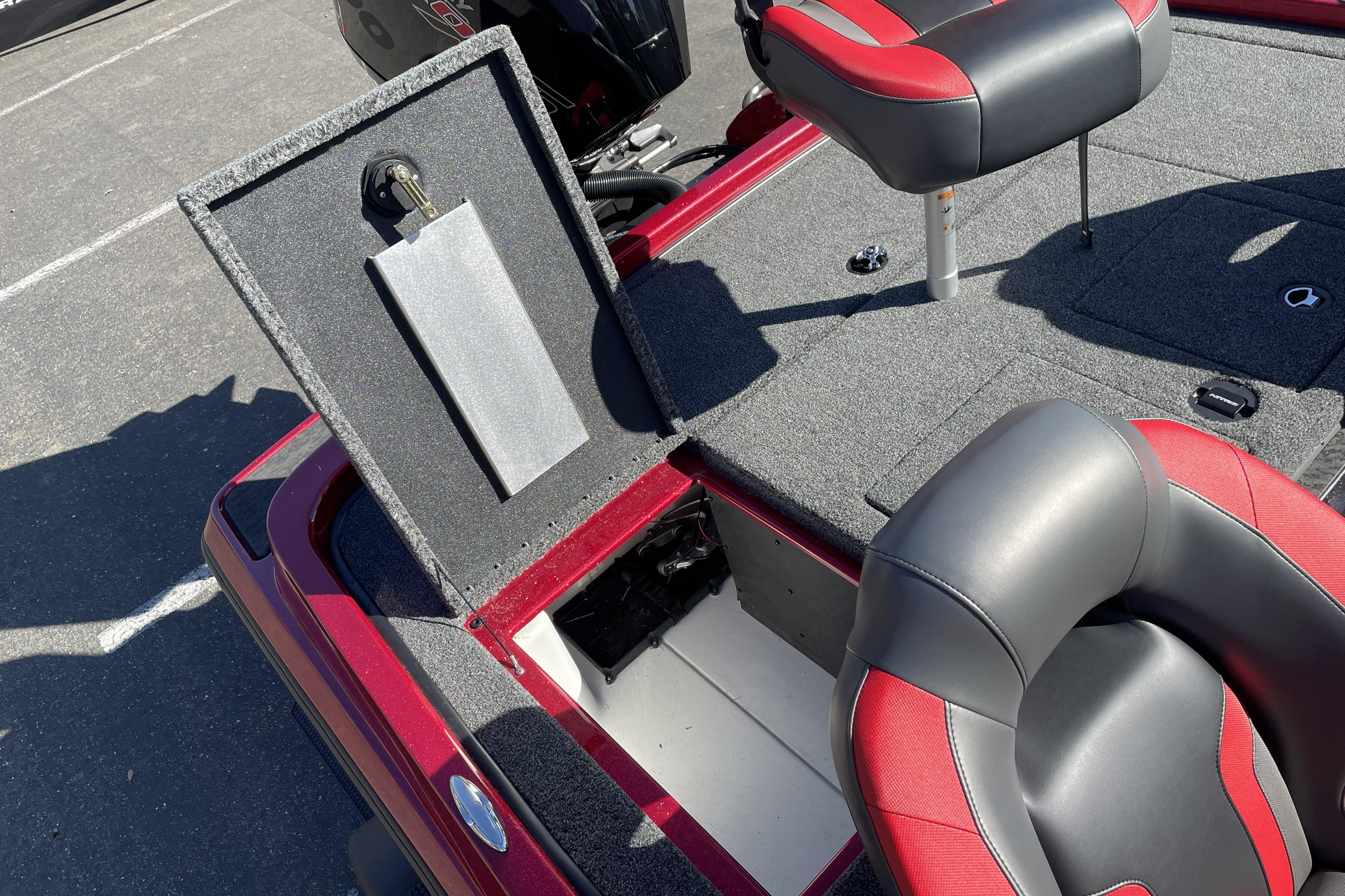 2026 Nitro Z19 XL boat interior with open storage compartment and red-gray seating.