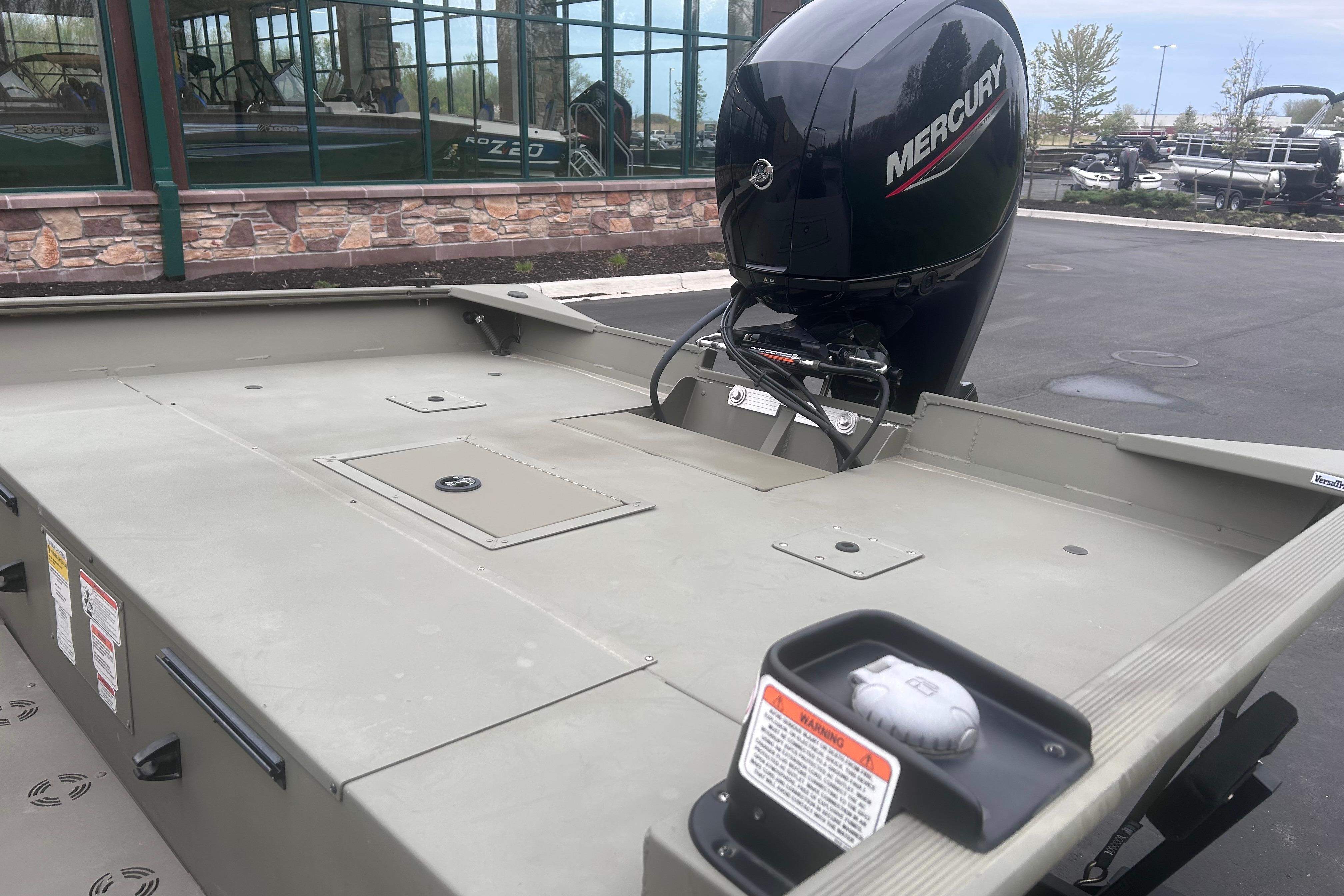 2024 Tracker Grizzly 2072 CC boat with Mercury outboard motor, parked outdoors.