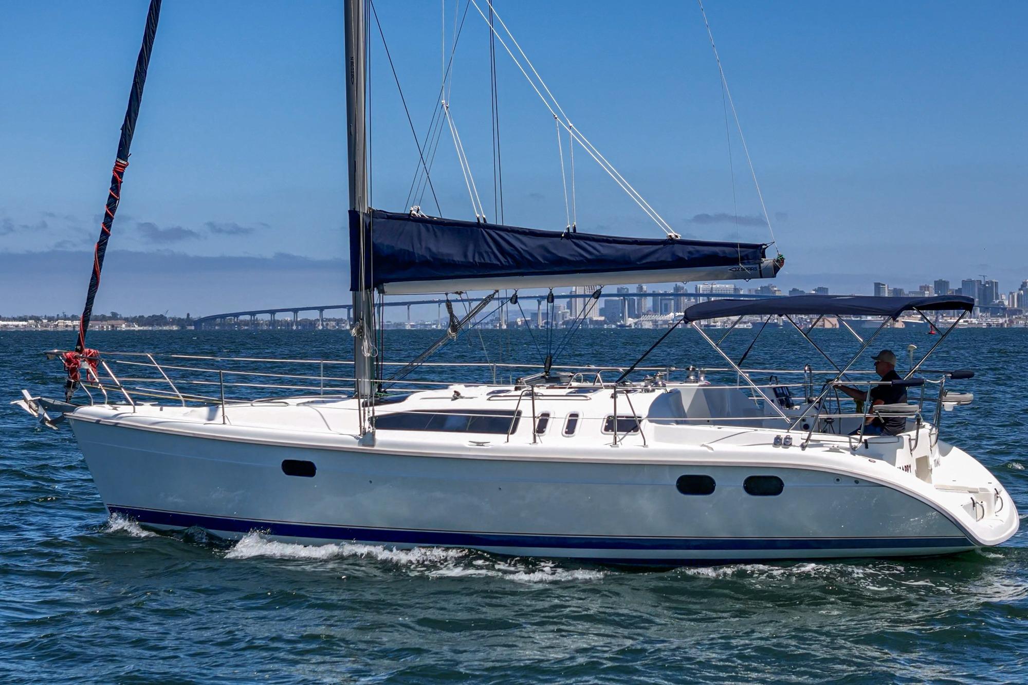Sailboat on water, 1996 Hunter 376 model, city skyline in background.