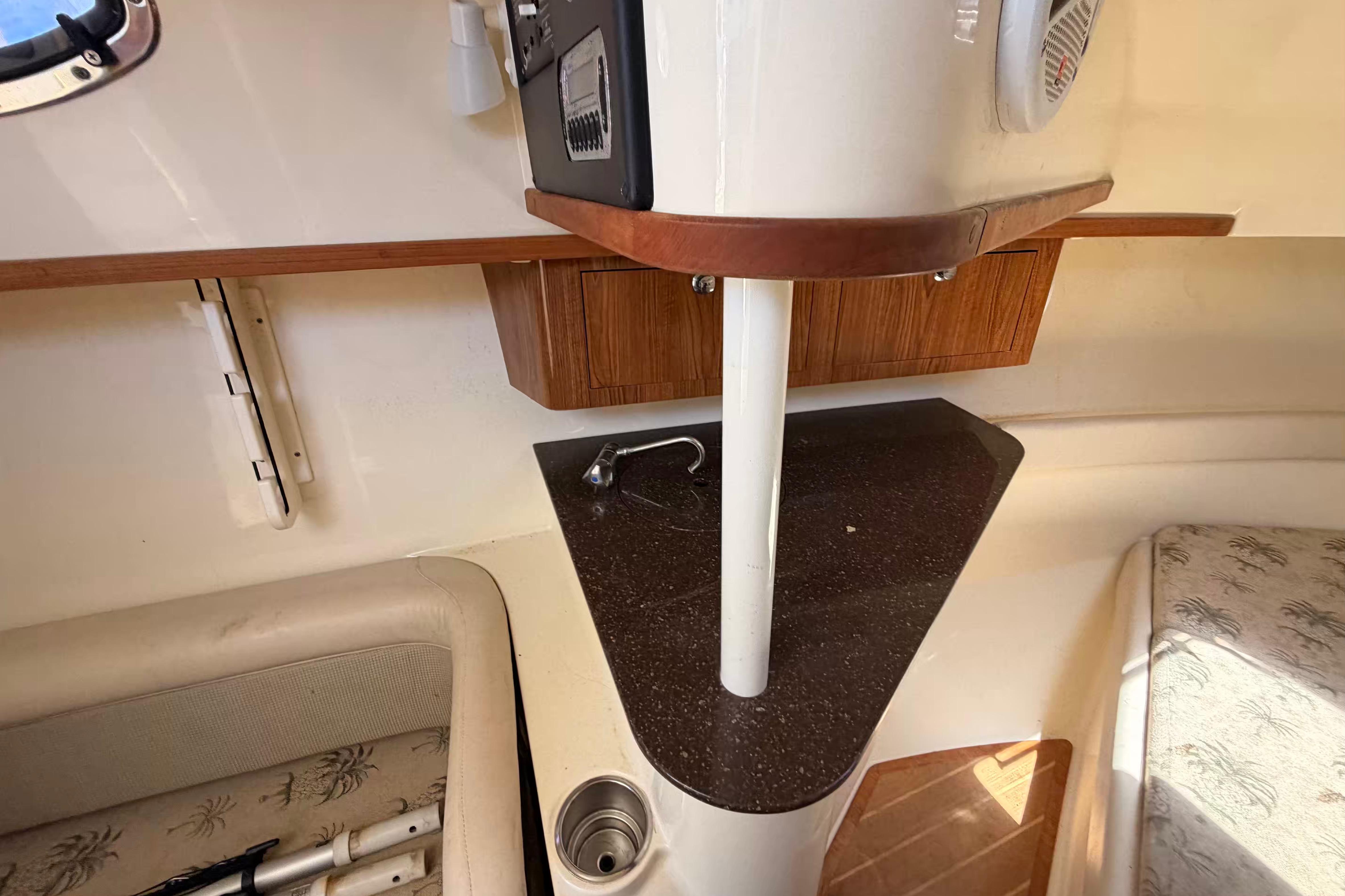 Interior of 2007 Scout 262 Abaco boat with seating and compact kitchenette.