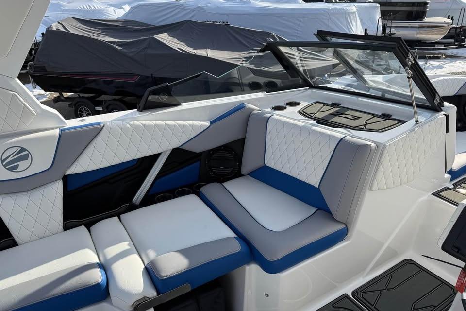 2026 Tigé Z3 boat interior with white and blue cushioned seating.