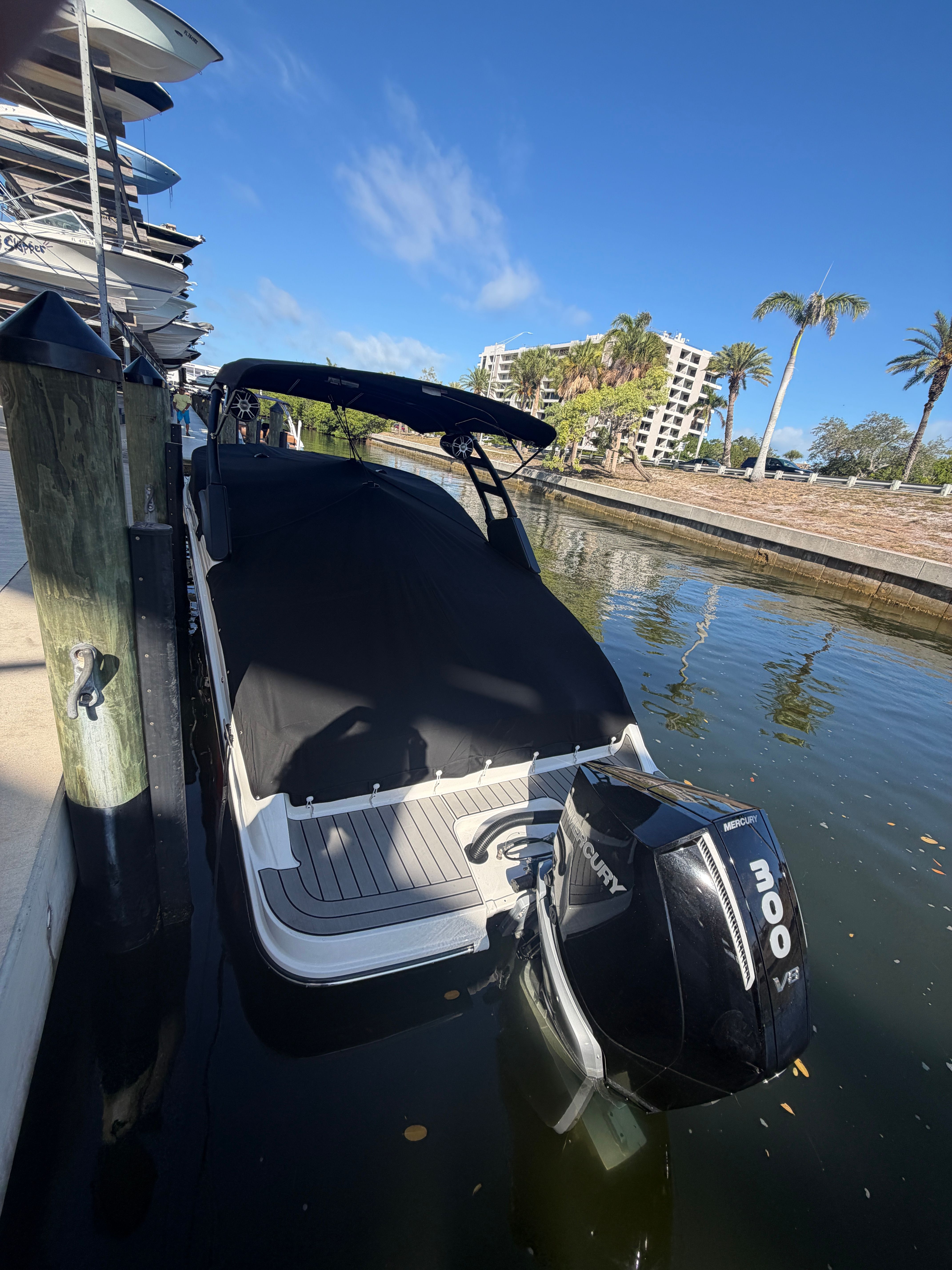 A 2025 Sea Ray SDX 250 Outboard is docked. It features a black outboard motor.