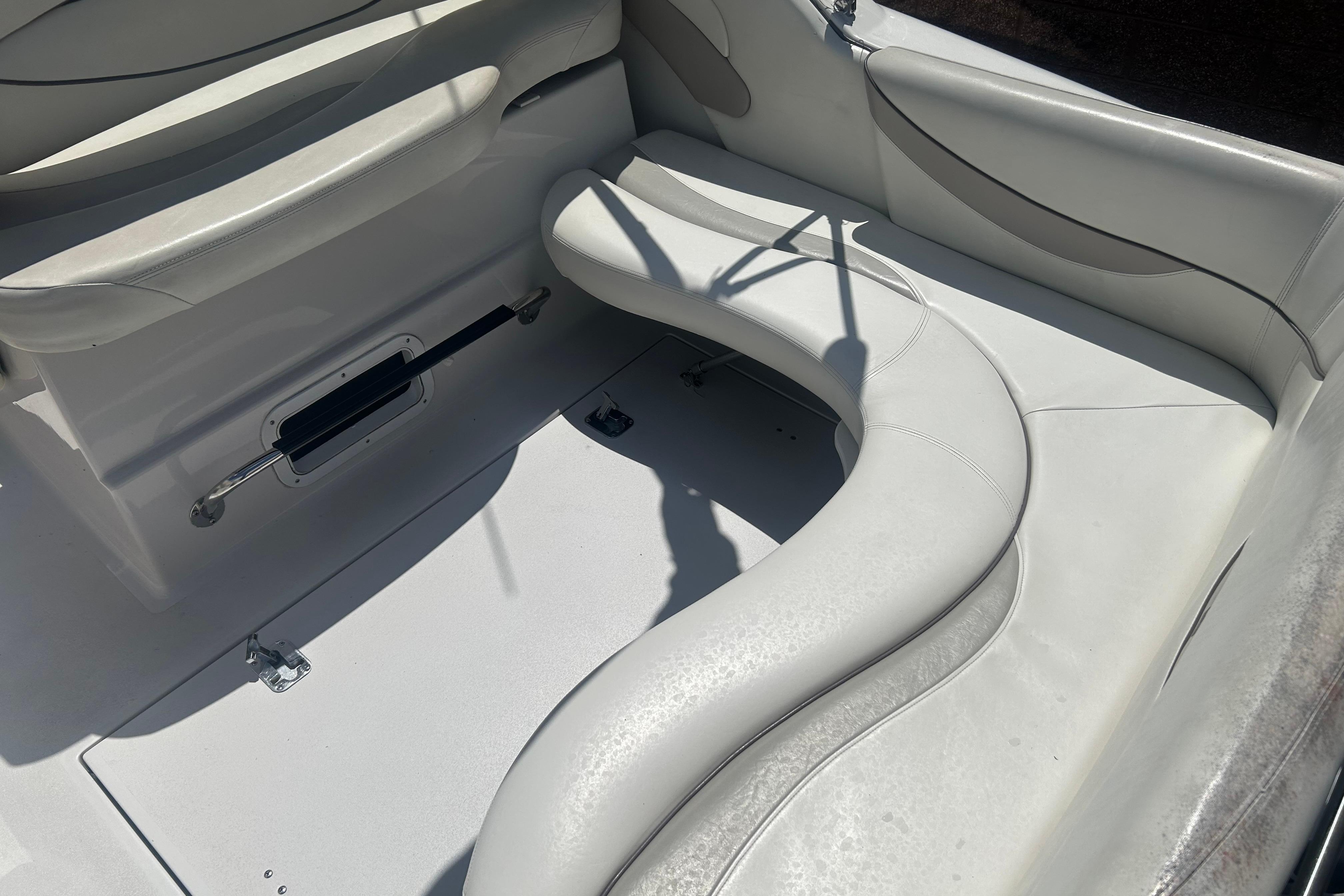 1998 Four Winns 258 Vista boat interior with white cushioned seating.