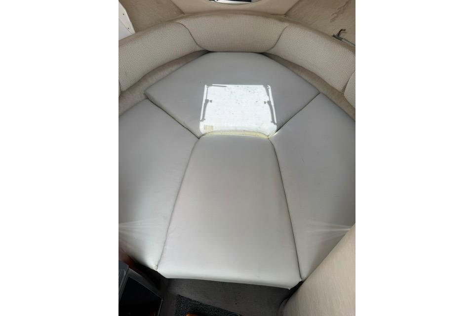 Interior cabin of 2004 Sea Ray 240 Sundancer boat with cushioned seating.
