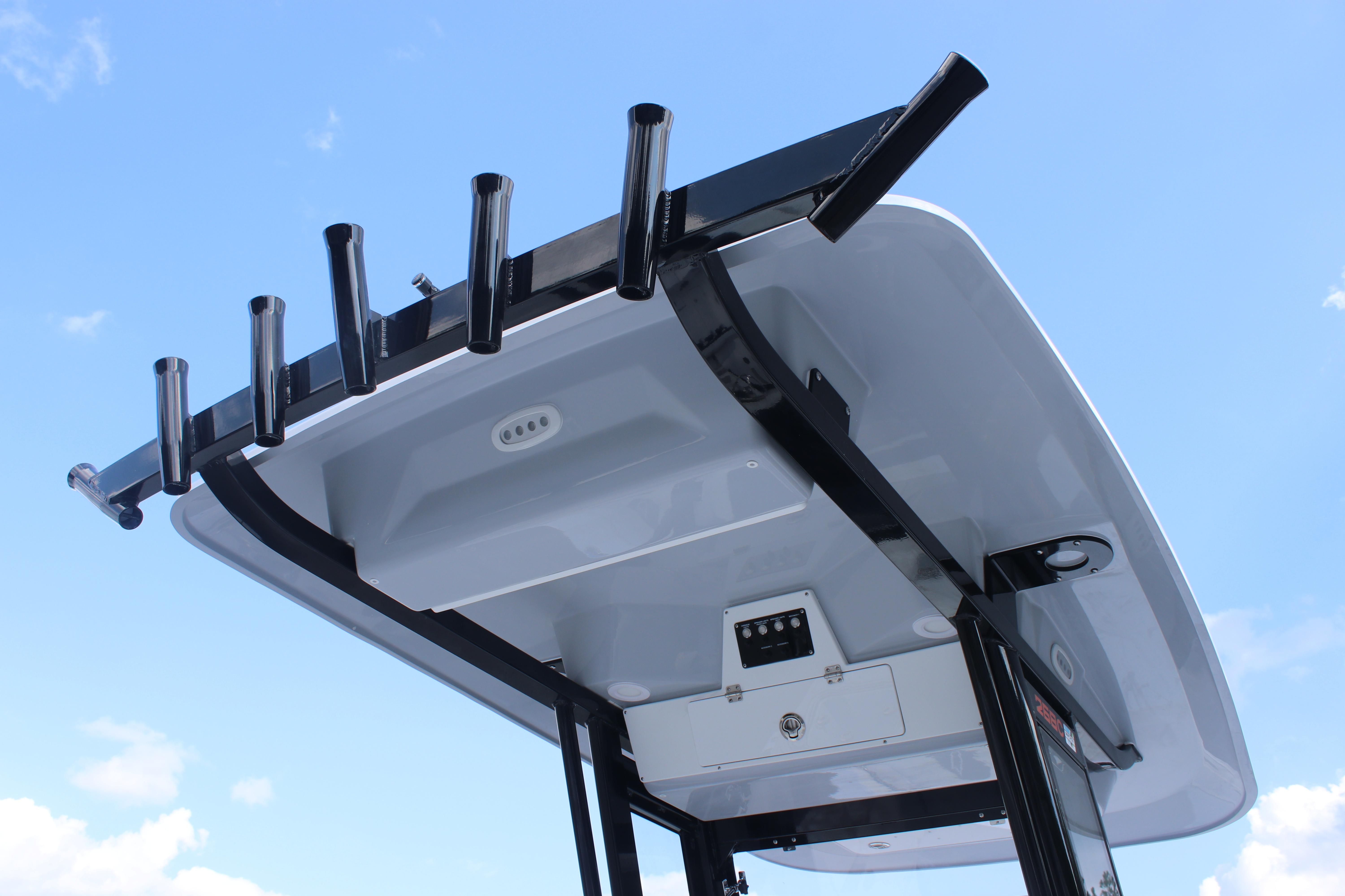 2026 Sea Fox 268 Commander T-top with rod holders against blue sky.