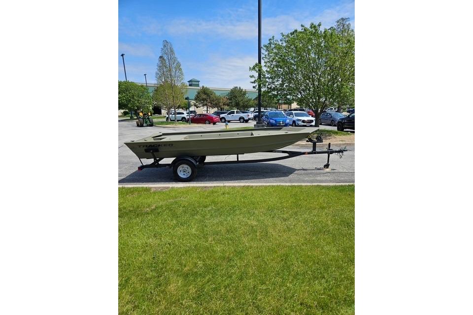 2026 Tracker Grizzly 1754 Utility boat on trailer in parking lot.