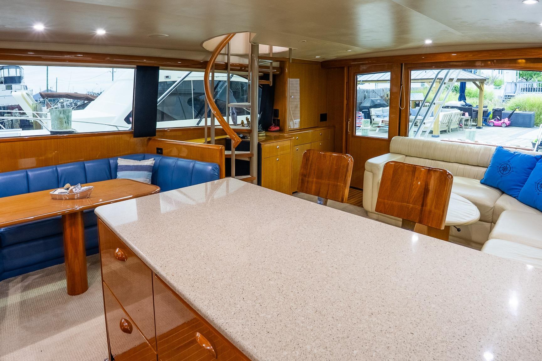 Luxurious interior of 2002 Viking 61 Enclosed Bridge yacht with elegant seating and dining area.