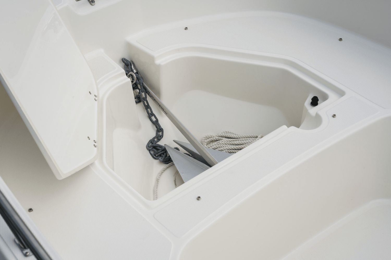 An anchor locker with anchor and rope on a boat.