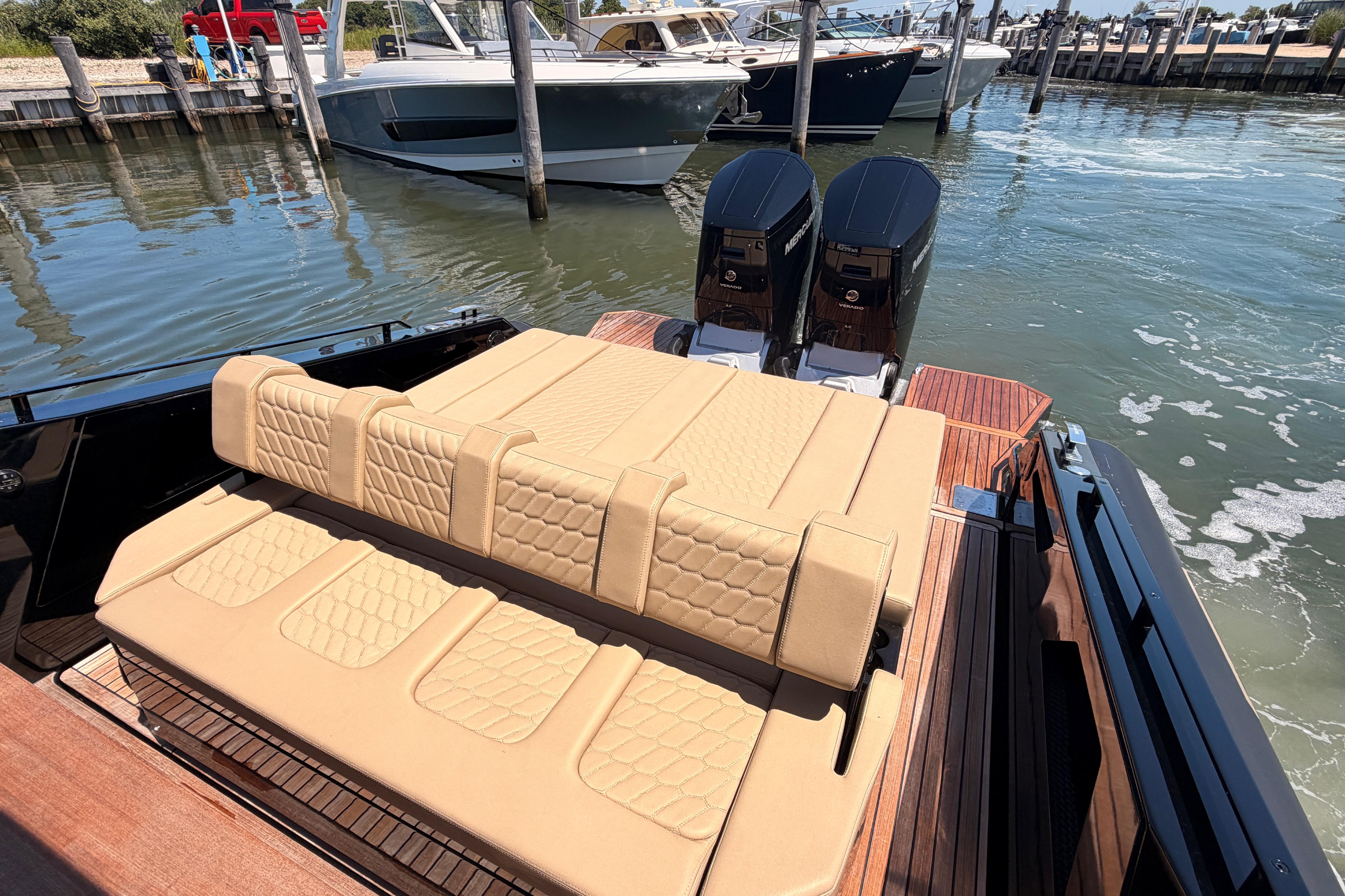 Luxury Skipper-BSK 42NC boat with beige seating and dual engines, docked in a marina.