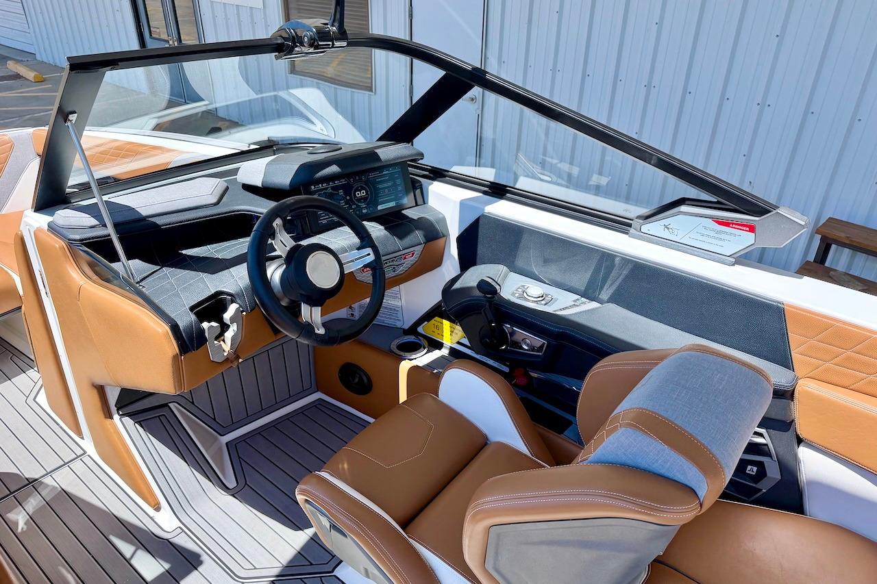 2021 Nautique Super Air Nautique G23 boat interior with modern dashboard and leather seating.