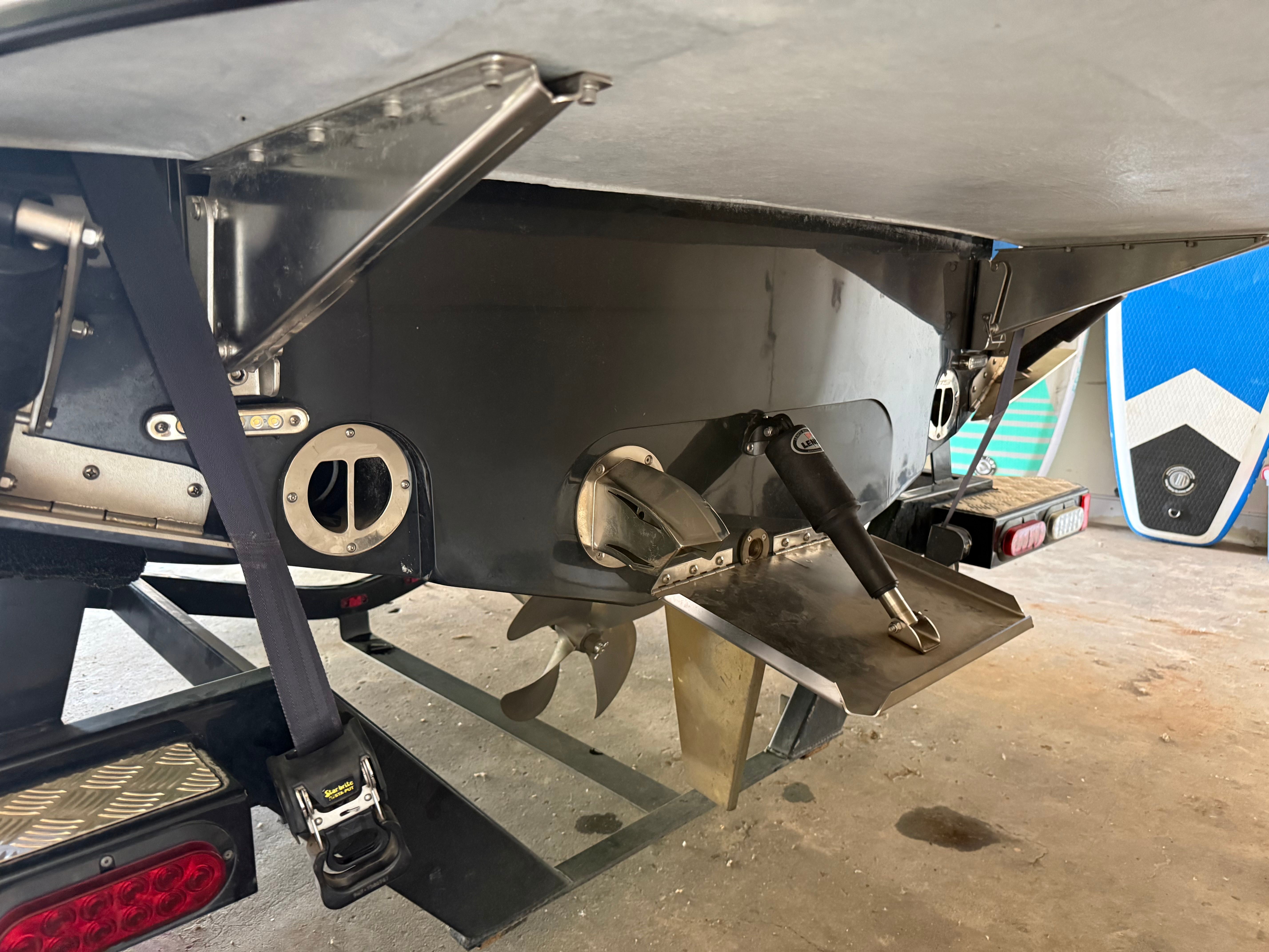 Close-up of a boat's stern with propeller and rudder system.